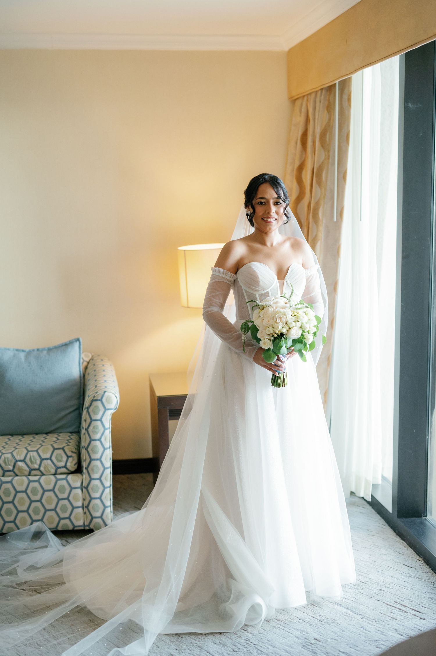 A series of bridal portraits showing a flowing white wedding gown and bouquet in a sunlit hotel room.