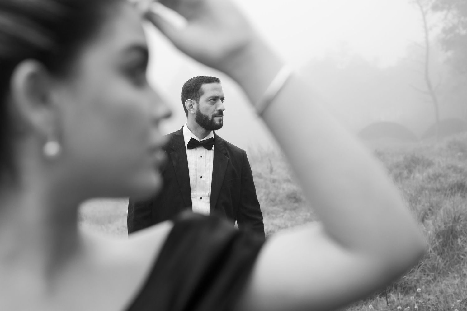 Artistic wedding portraits captured in soft focus with natural outdoor lighting.