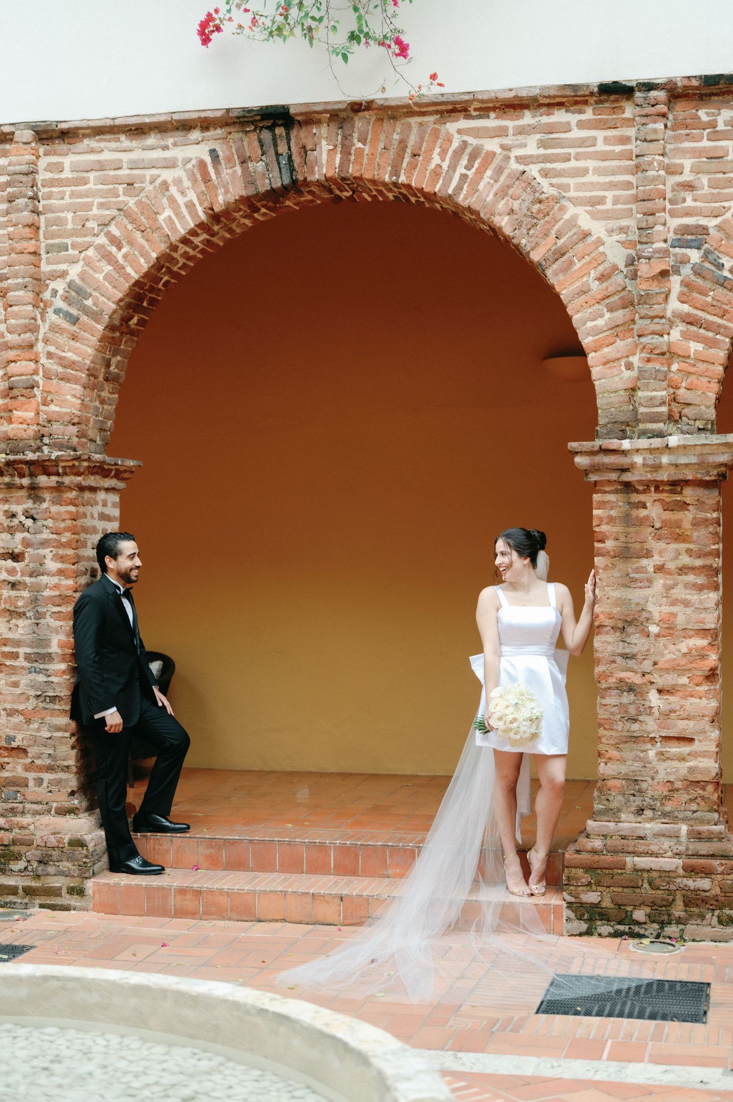 A sequence of wedding photos showing a couple in a rustic brick archway setting.