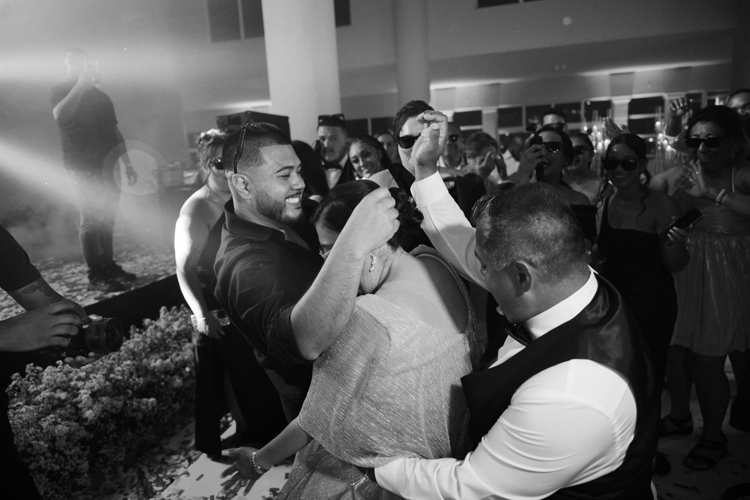 A group of people dancing and socializing at a lively party or celebration event.