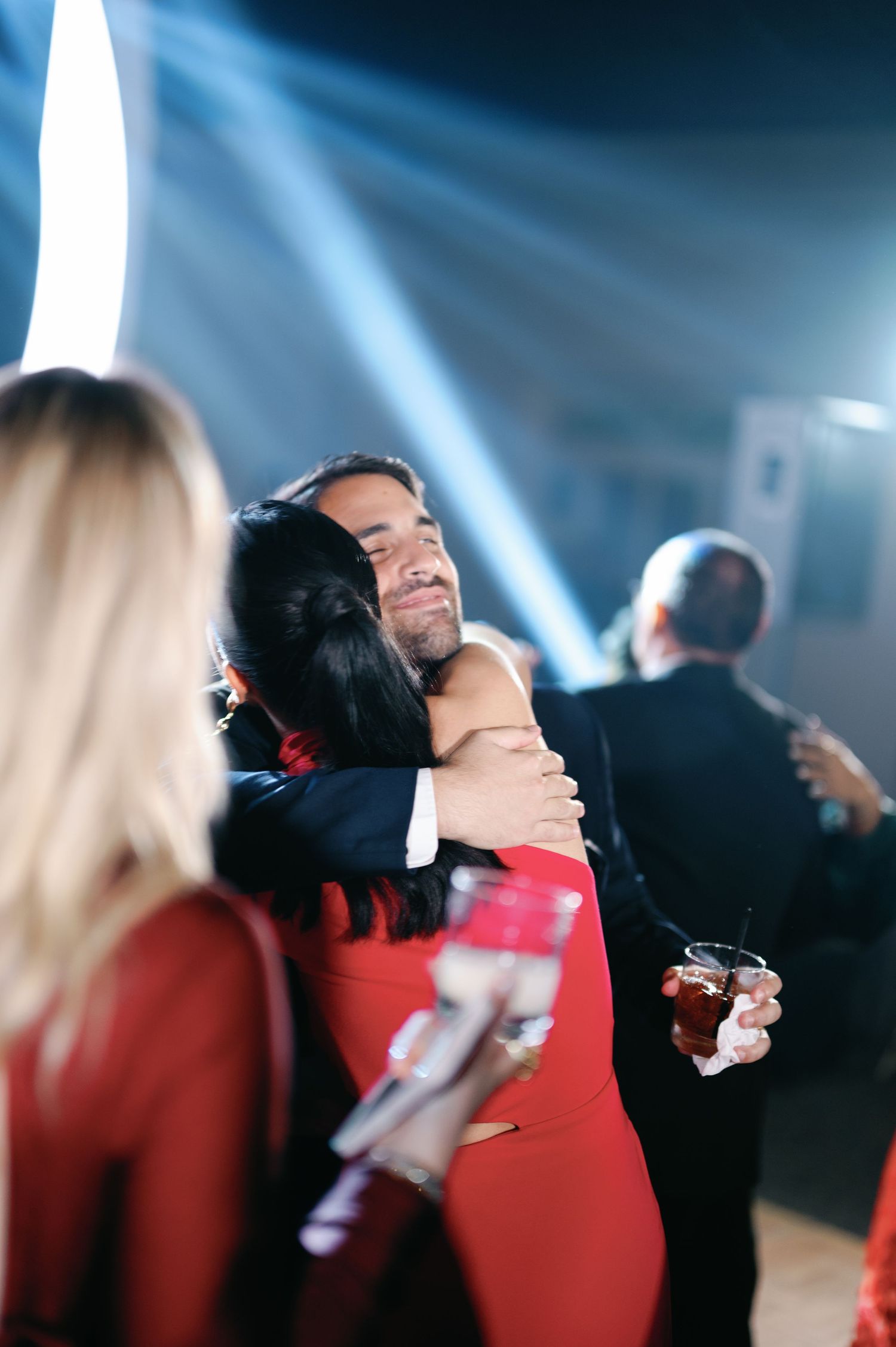 A sequence of motion shots showing two people in red clothing embracing against a dramatic blue-lit background.