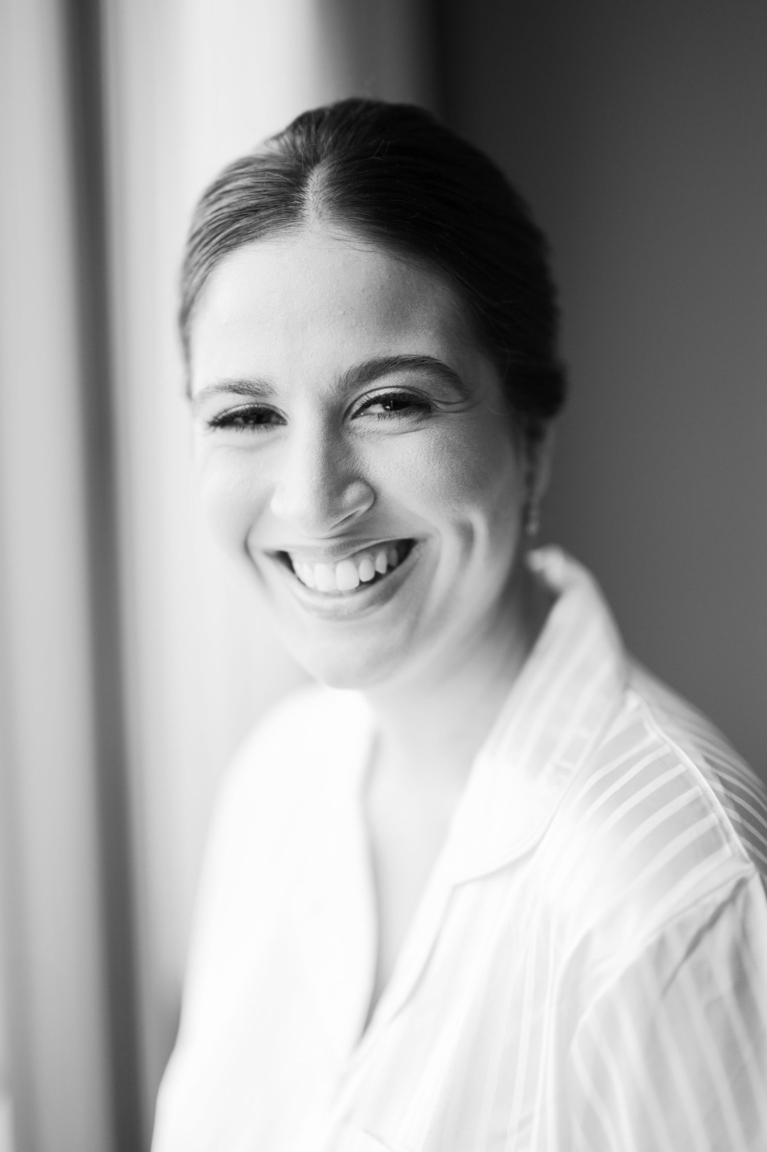 Black and white portraits capturing genuine smiles and emotions in a bright white shirt.
