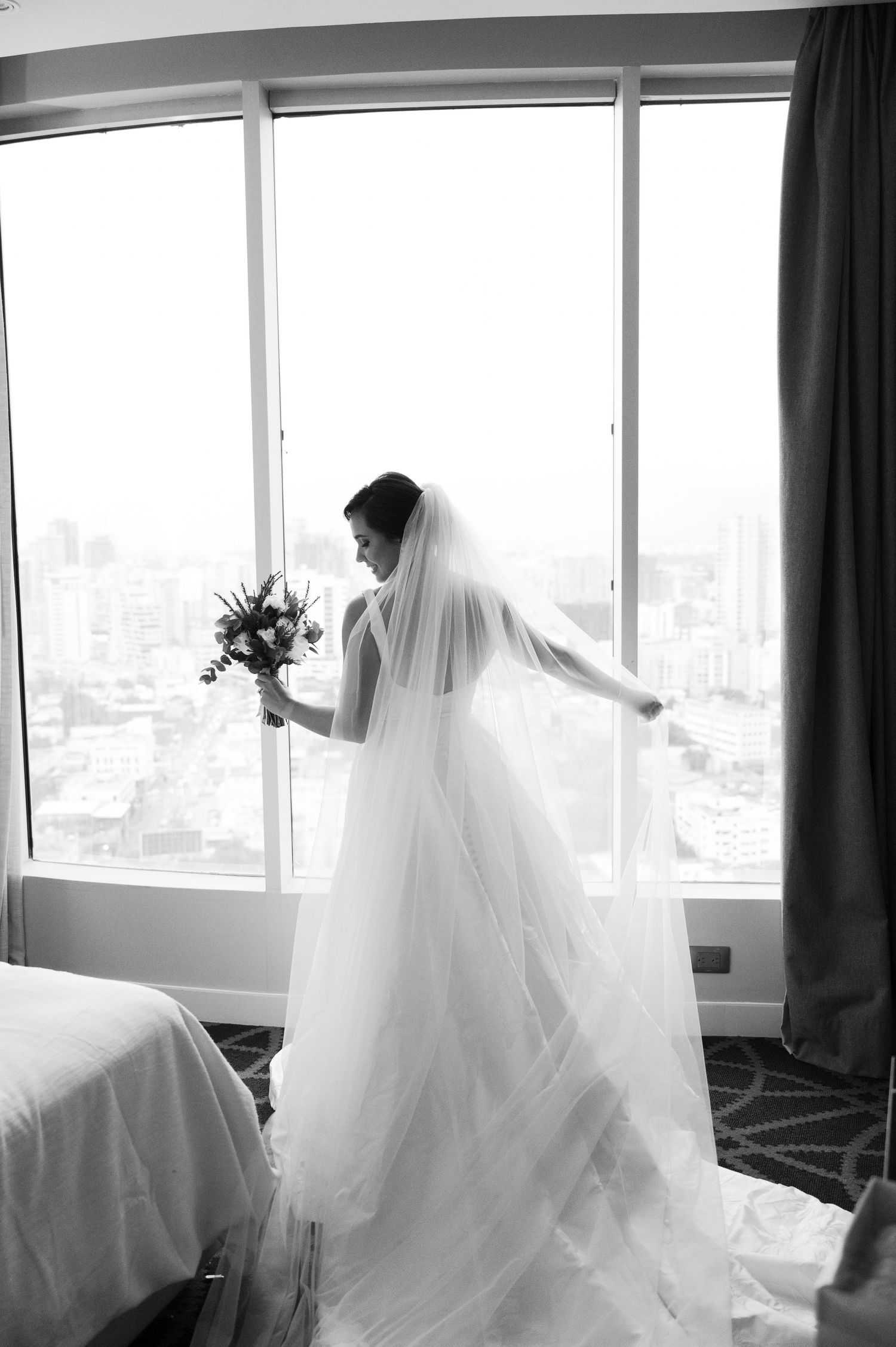 A series of black and white photos showing a bride in flowing white dress and veil silhouetted against bright windows.