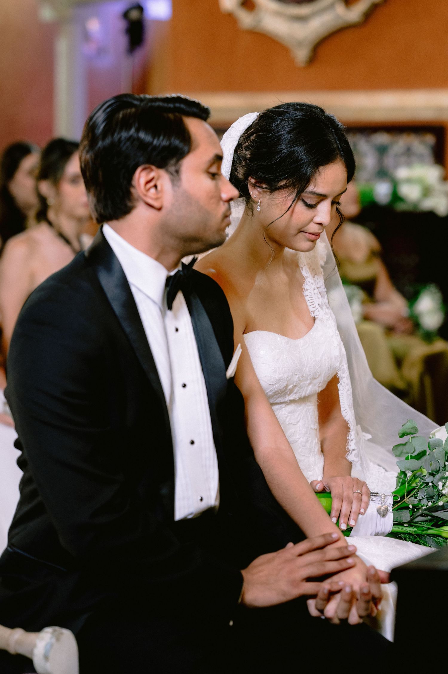 Romantic wedding couple shares intimate moments in formal attire at their reception celebration.