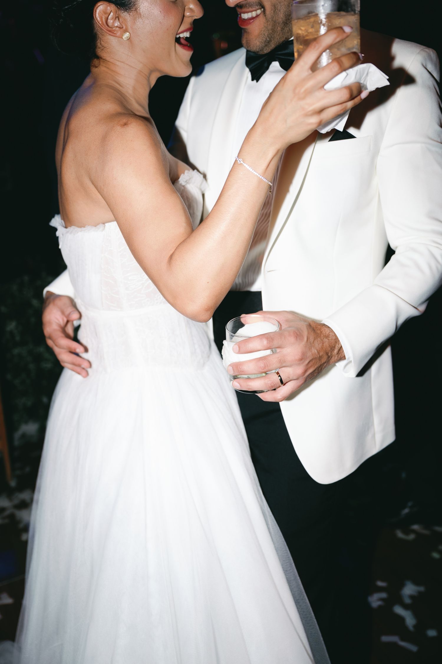 A romantic wedding dance sequence showing a couple in white formal attire sharing joyful moments on their special day.