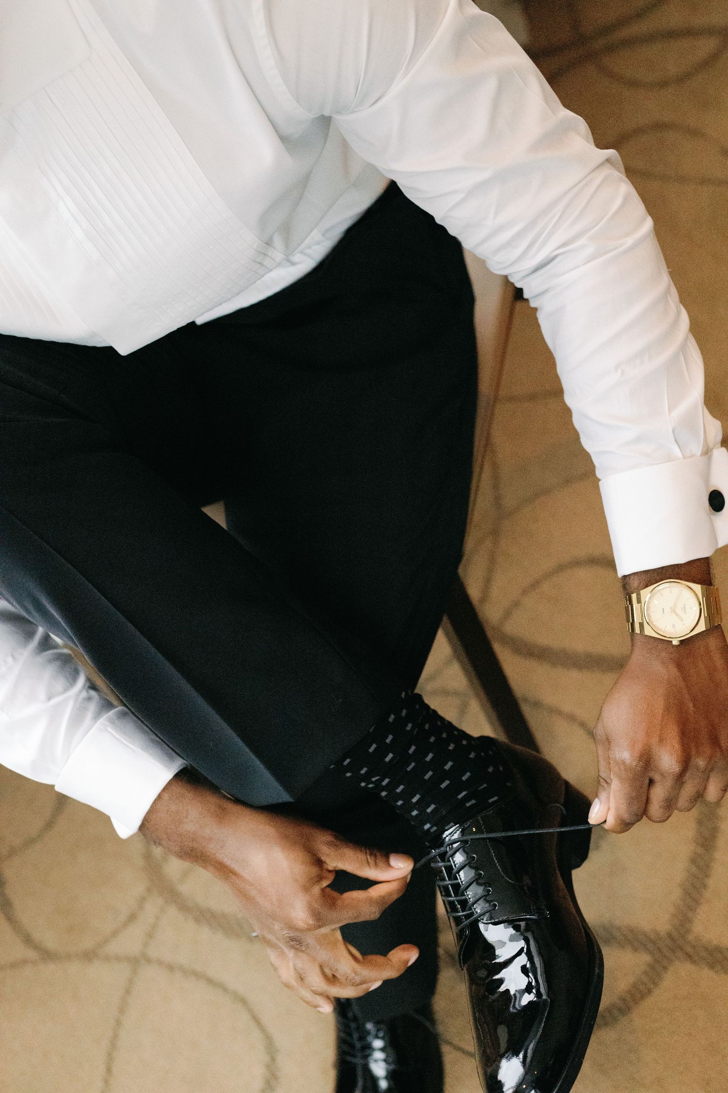 A series of close-up shots showing hands tying black dress shoes with formal attire.