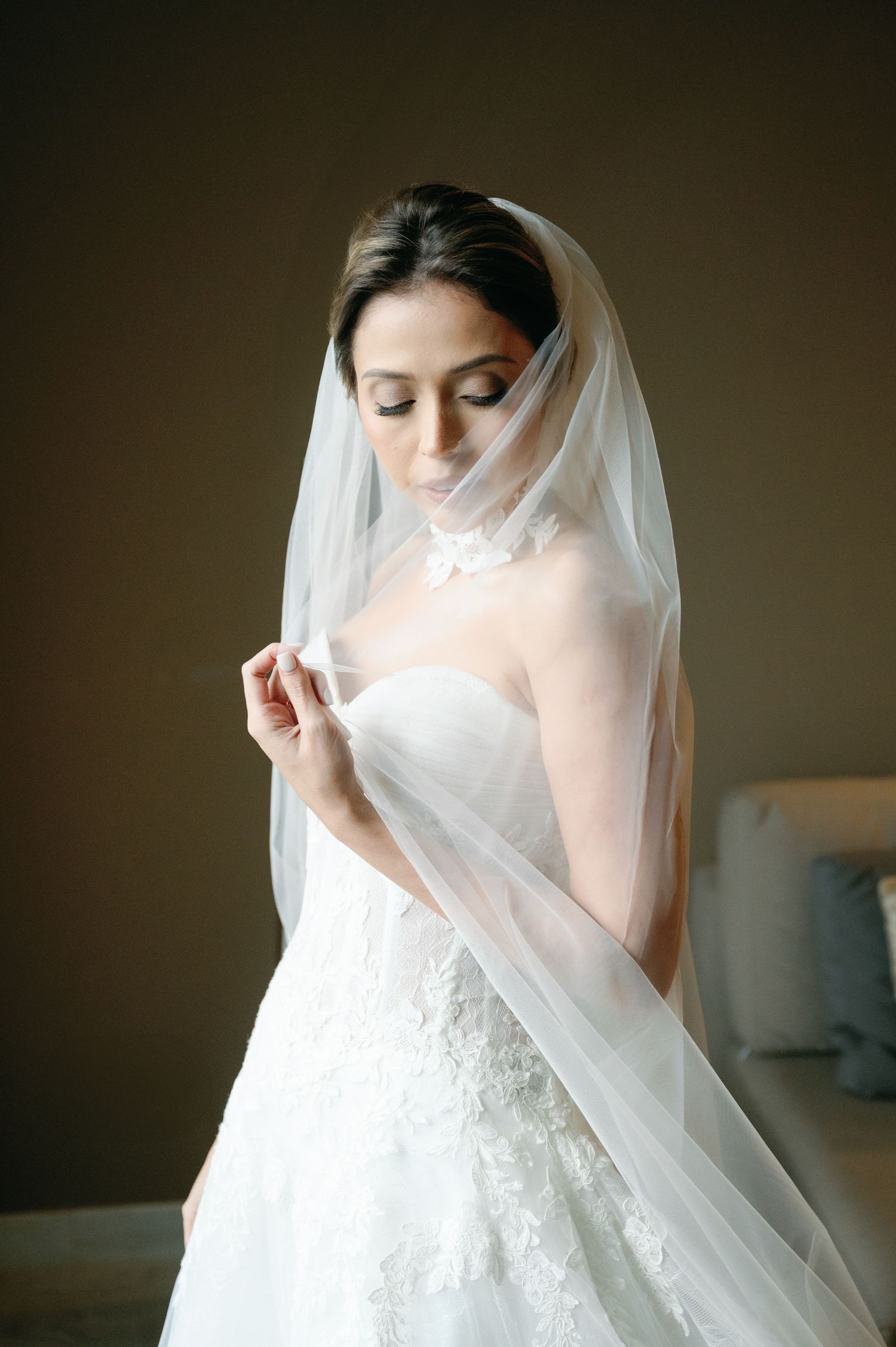 Elegant bridal portrait series showing delicate details of a white lace wedding gown and flowing veil.