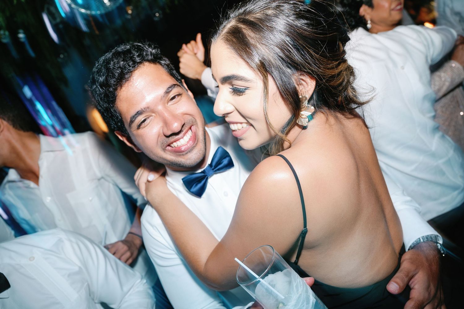 Couples dancing and celebrating together at a lively wedding reception party.