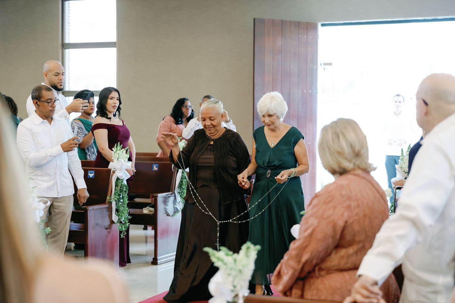Wedding guests mingling and socializing in a modern reception venue.