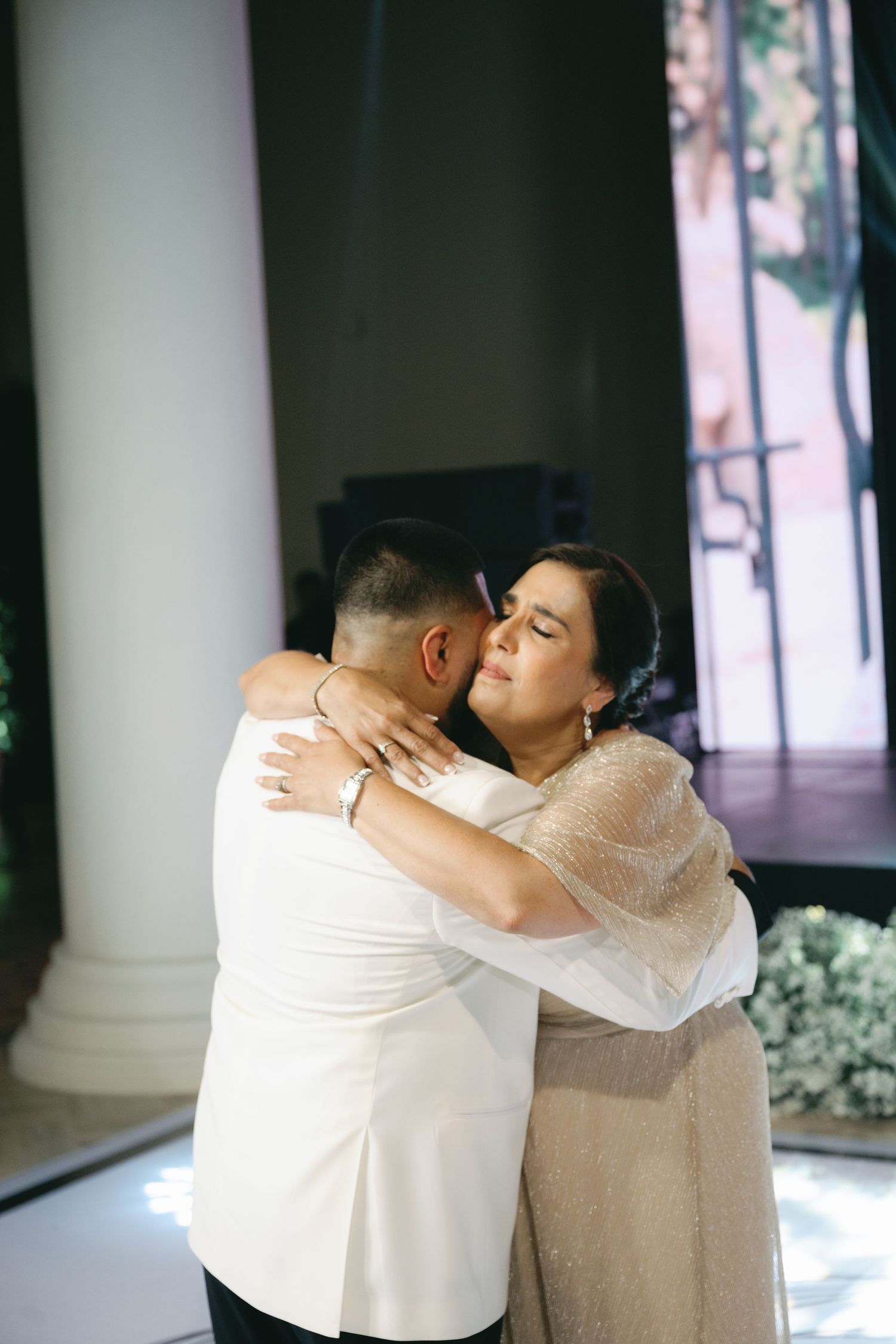 A tender moment shared between a couple during their wedding dance in an elegant venue.