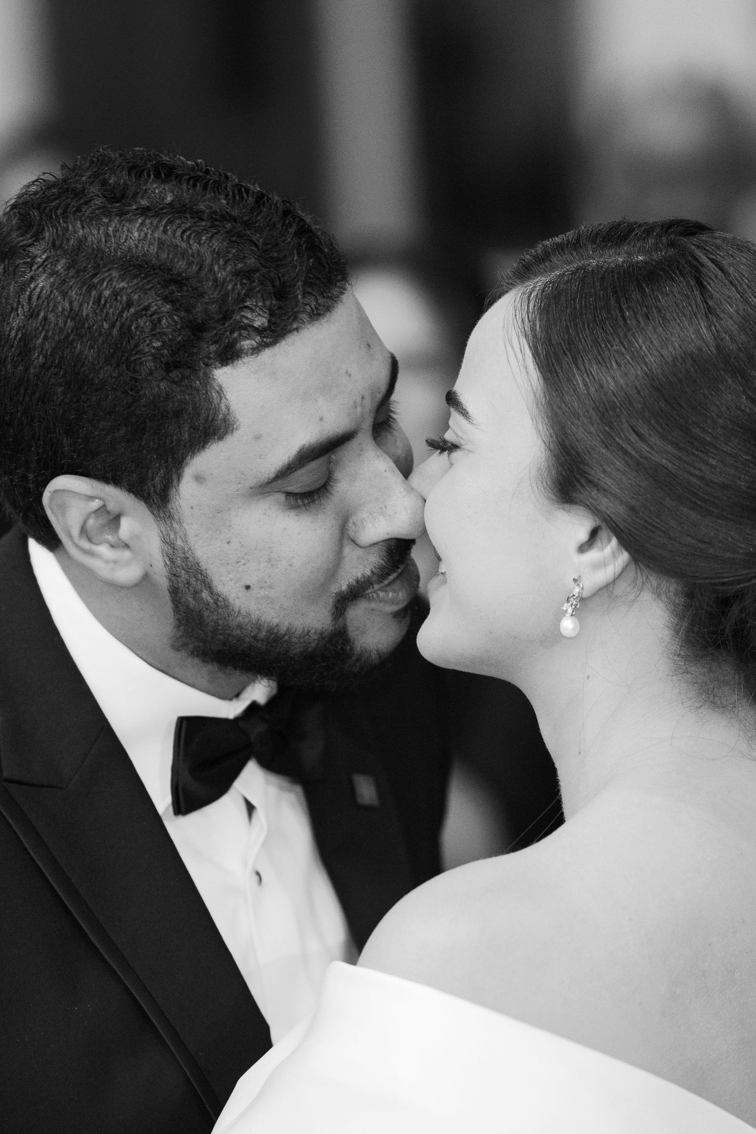 A romantic black and white photo series showing a couple in formal attire about to kiss in multiple close-up shots.