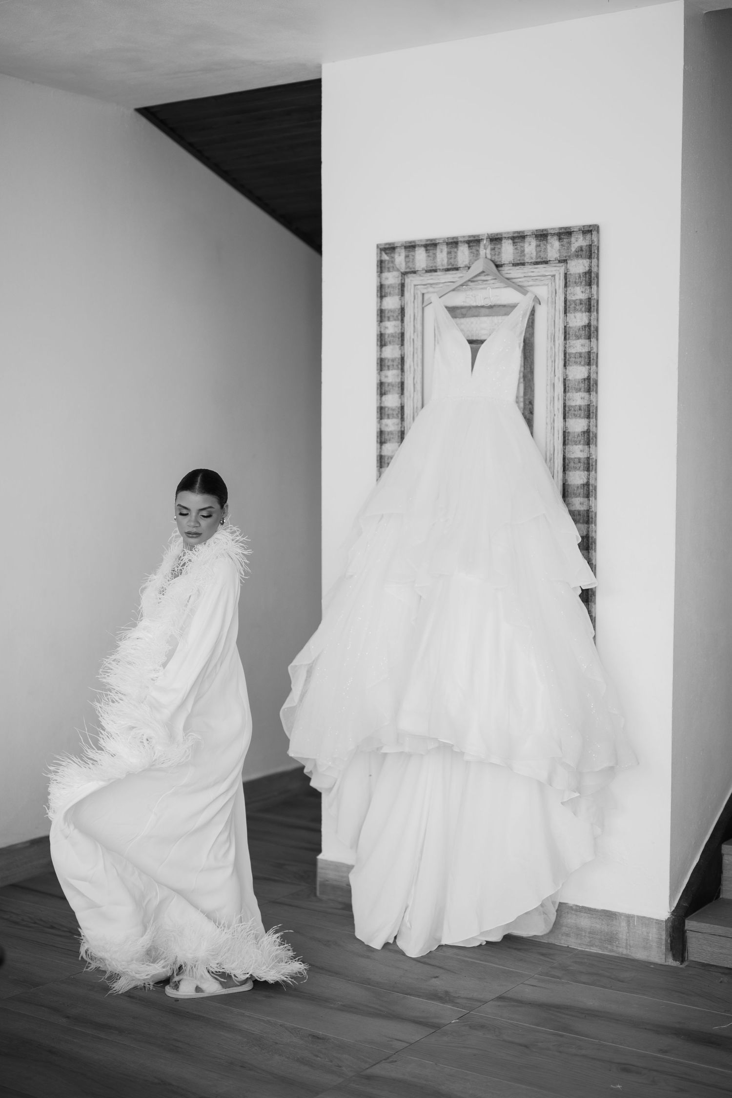 A sequence of black and white photos showing a flowing white wedding dress in motion against a minimalist interior setting.
