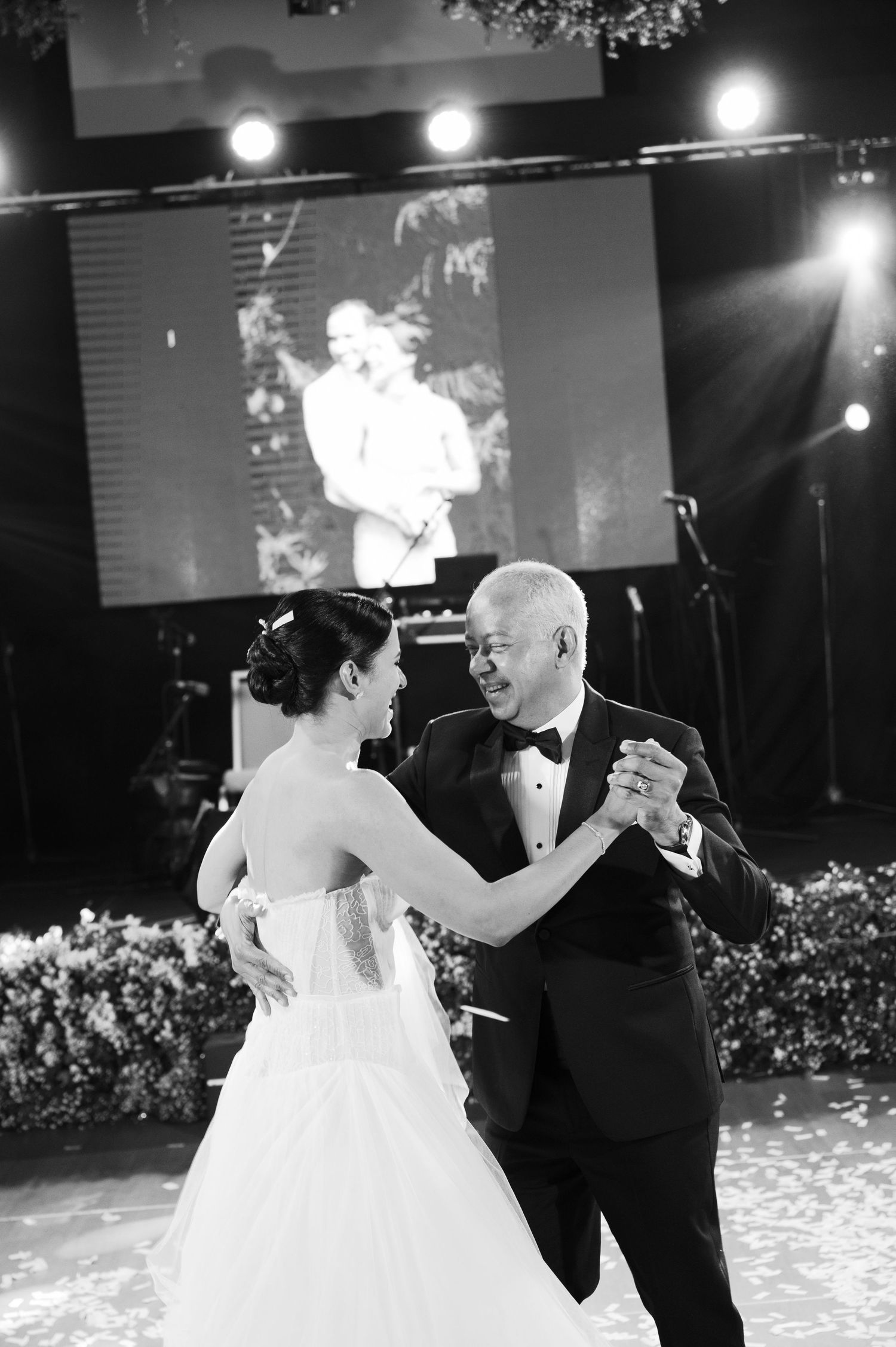 Black and white photos capture a heartfelt father-daughter dance at an elegant wedding reception.