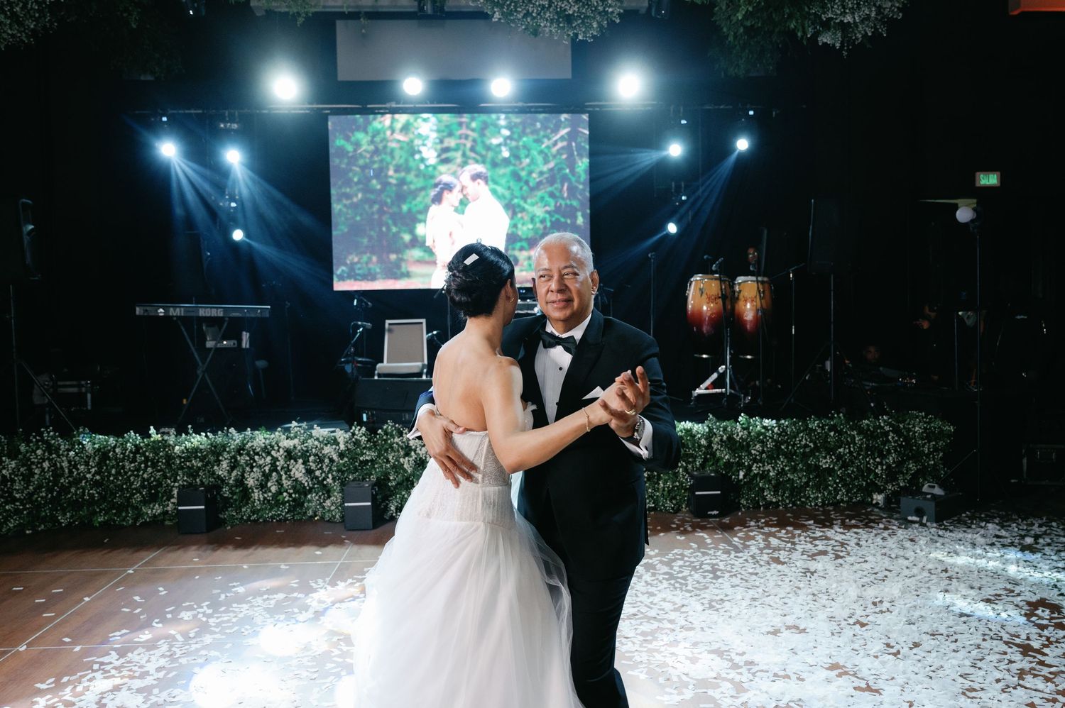 A romantic first dance at a wedding reception with snow effects creating a magical winter atmosphere.