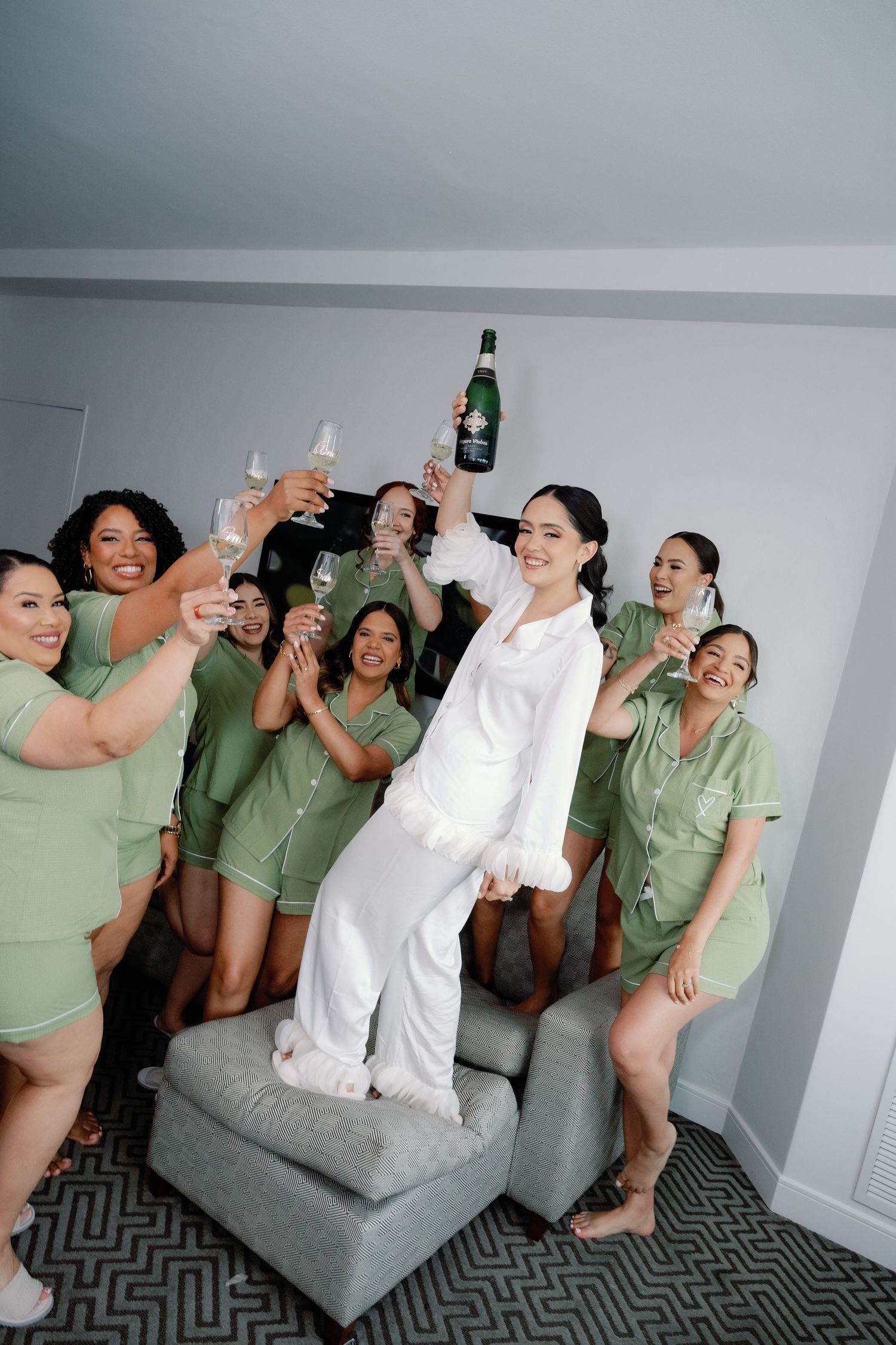 A sequence of party photos showing people in mint green outfits celebrating with drinks on a gray couch.