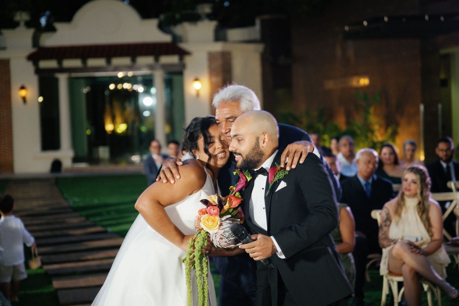 Wedding guests dance and celebrate on a festive dance floor during an evening reception.
