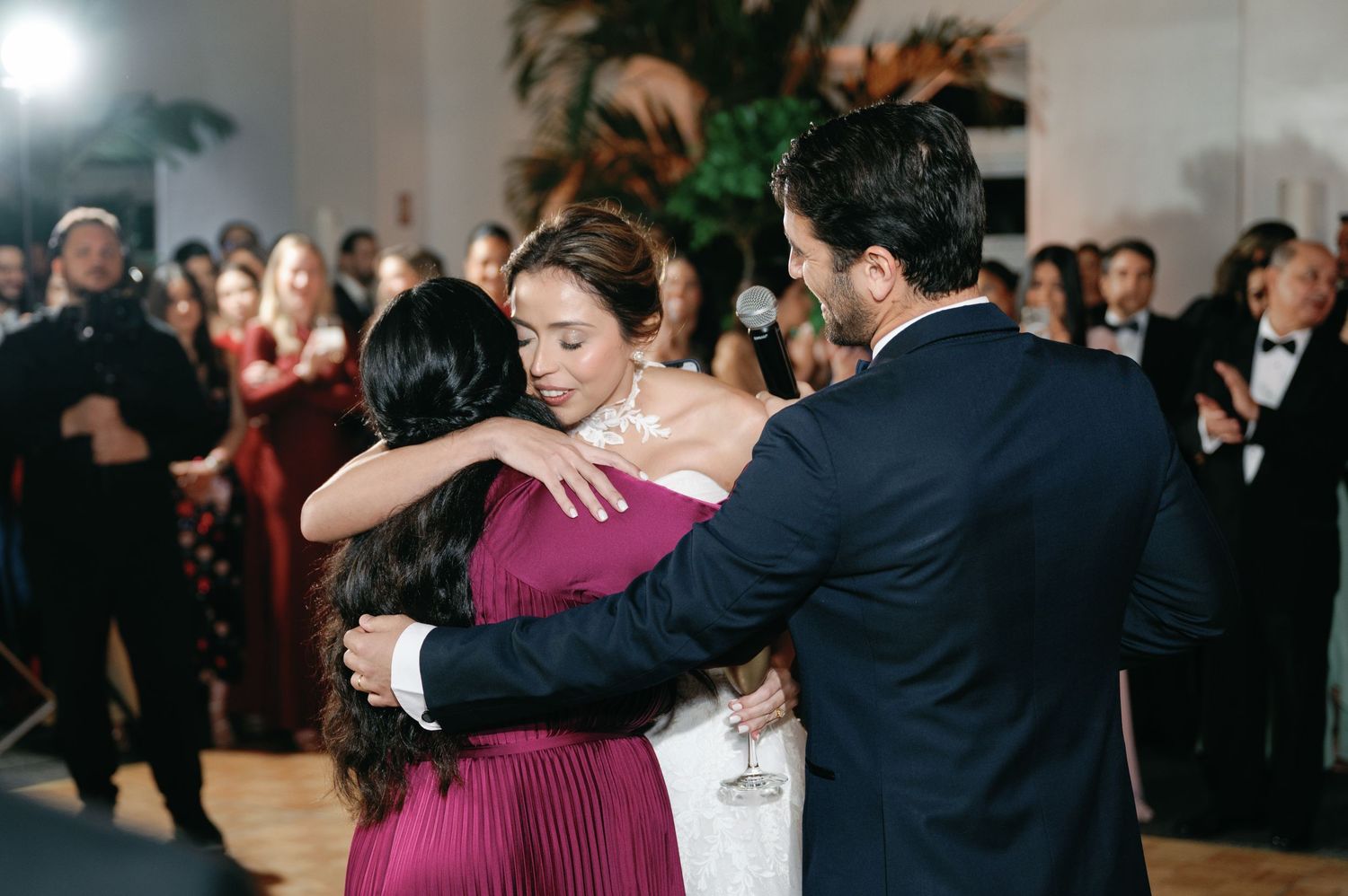 Wedding guests dance and mingle during the reception with elegant evening attire.