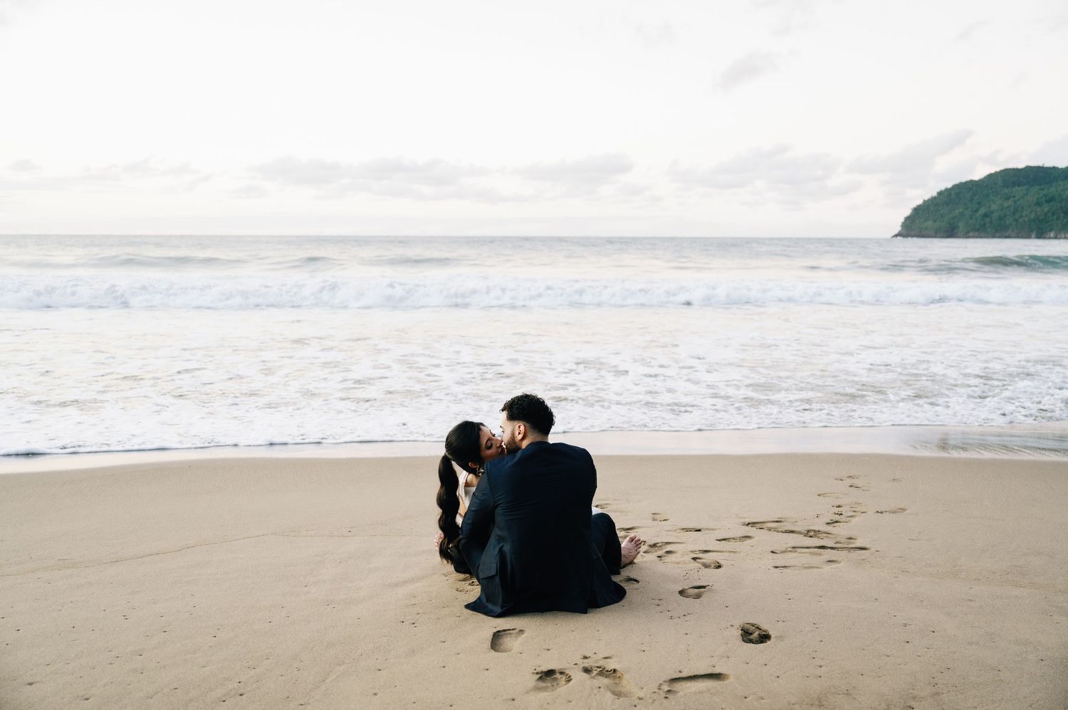 A romantic stroll along a misty beach with waves crashing in the background.