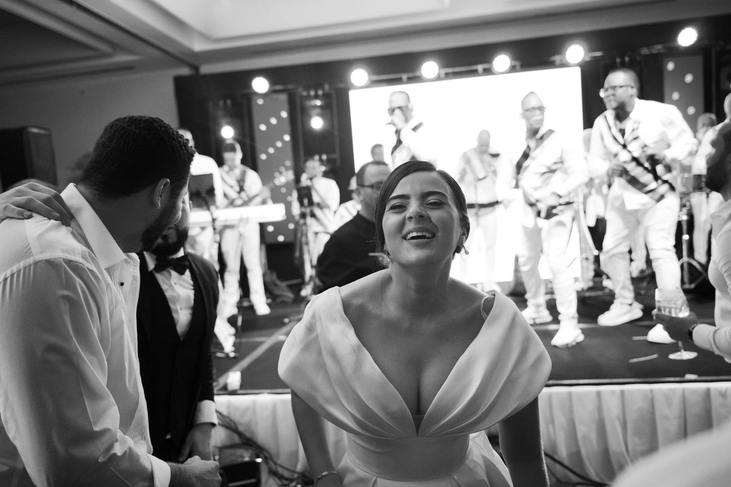 Black and white photos show a joyous wedding reception celebration with dancing and candid moments on the dance floor.