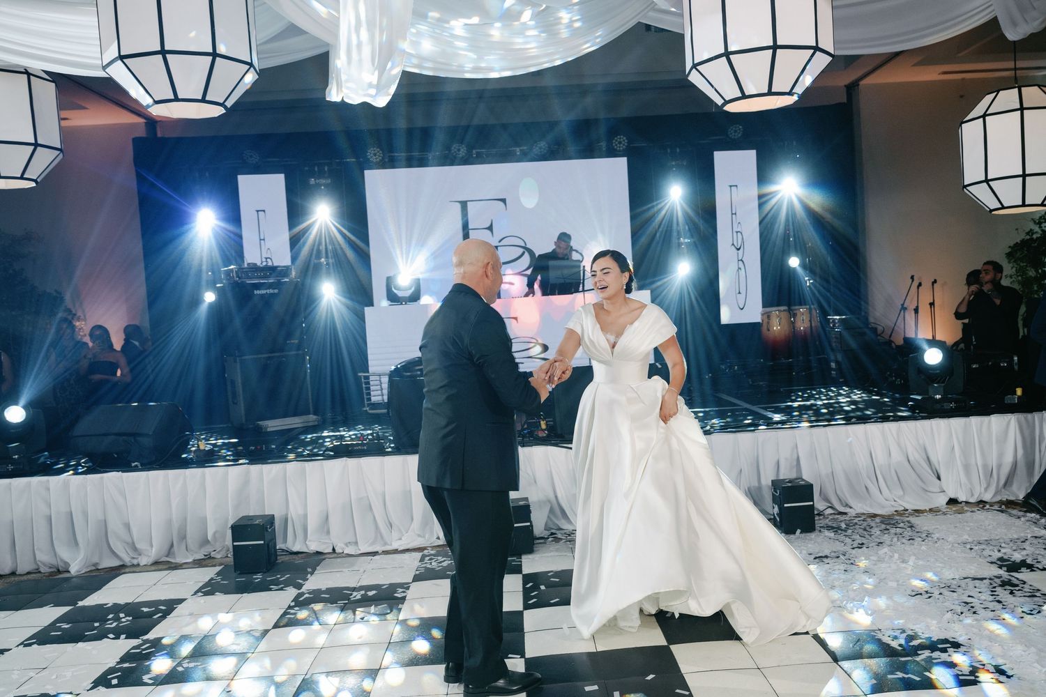 Wedding reception venue decorated with white lanterns and ambient lighting creating a dreamy atmosphere.