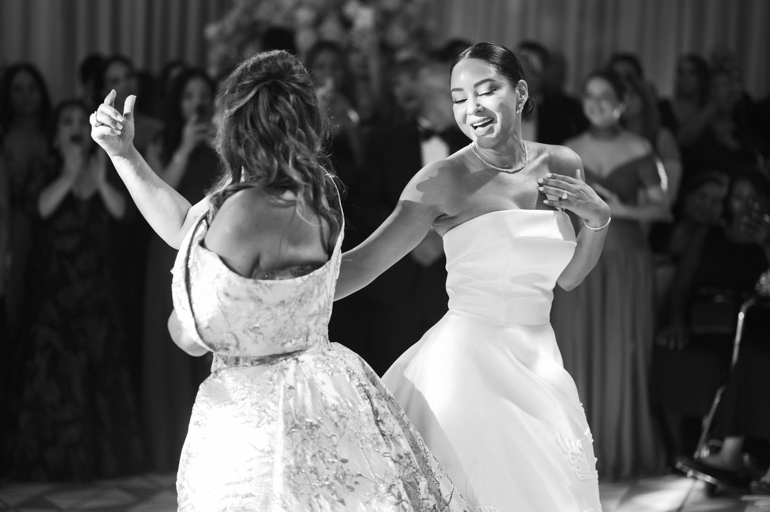 A graceful dancer in a white dress twirls elegantly on stage during a performance.
