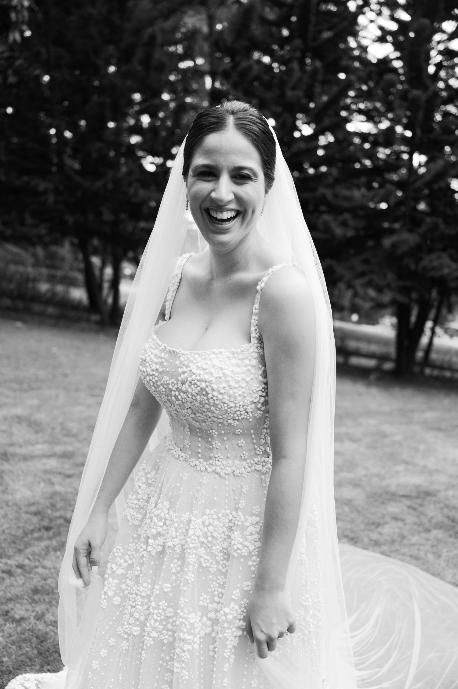 Close-up shots of a bride in an embellished wedding dress with delicate lace details and flowing veil.