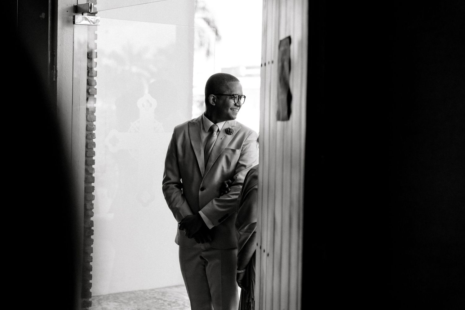 Black and white portrait series showing a contemplative figure standing in a doorway.