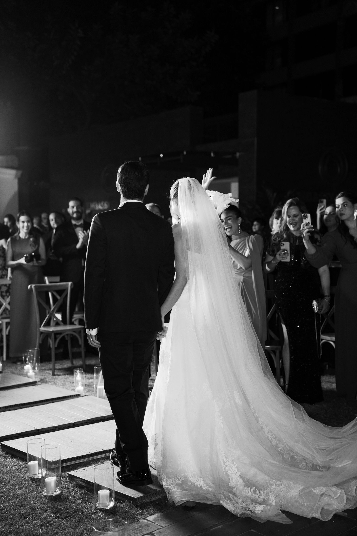 A series of black and white wedding photos showing a couple dancing at their reception on an illuminated dance floor.