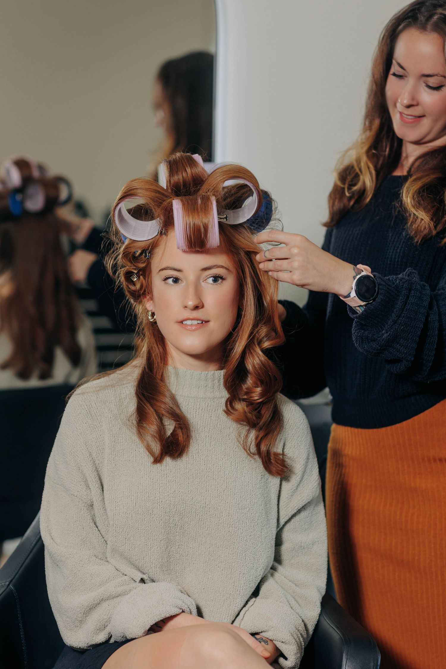 Behind the scenes hair styling session showing vintage pin curl technique.