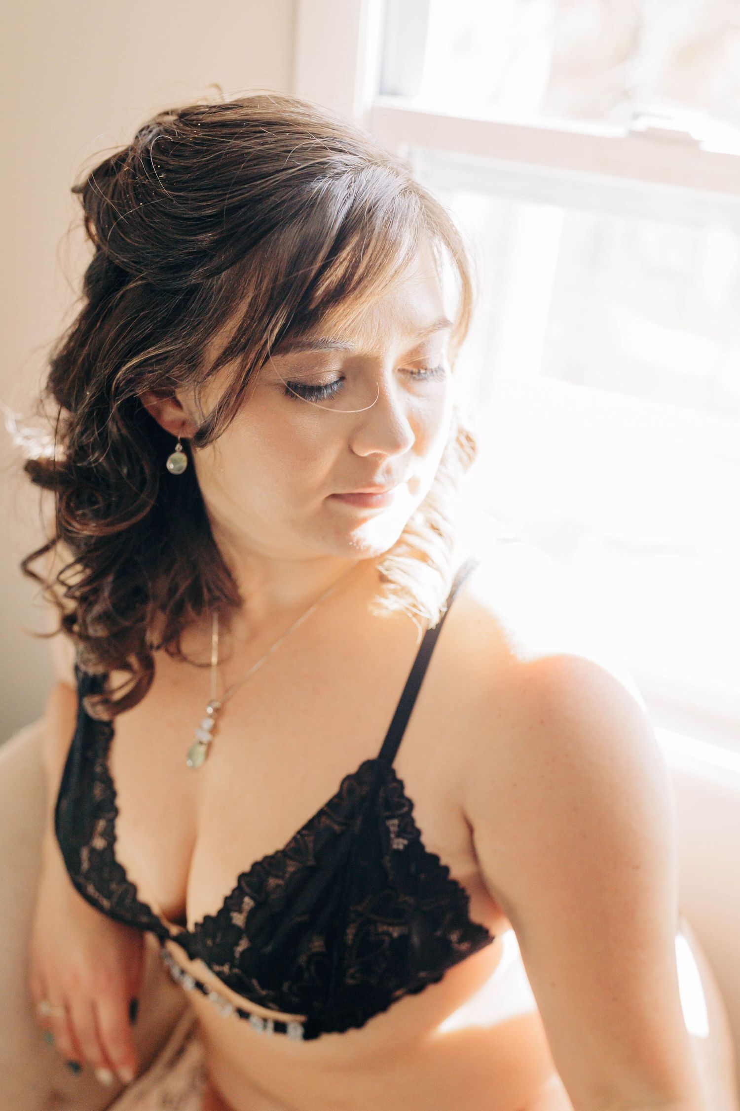 Soft window light portrait with delicate lace and romantic styling.
