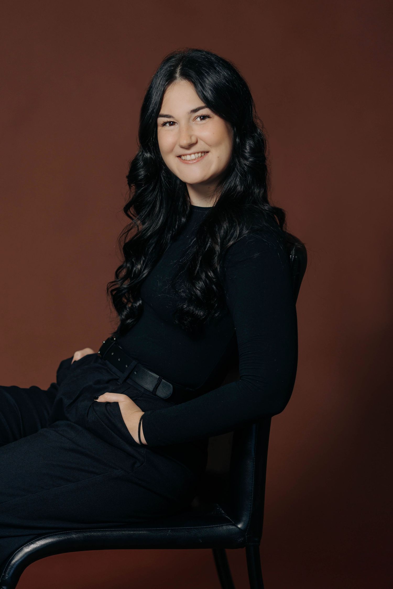 Glamour portrait series featuring black dress poses against dark background.
