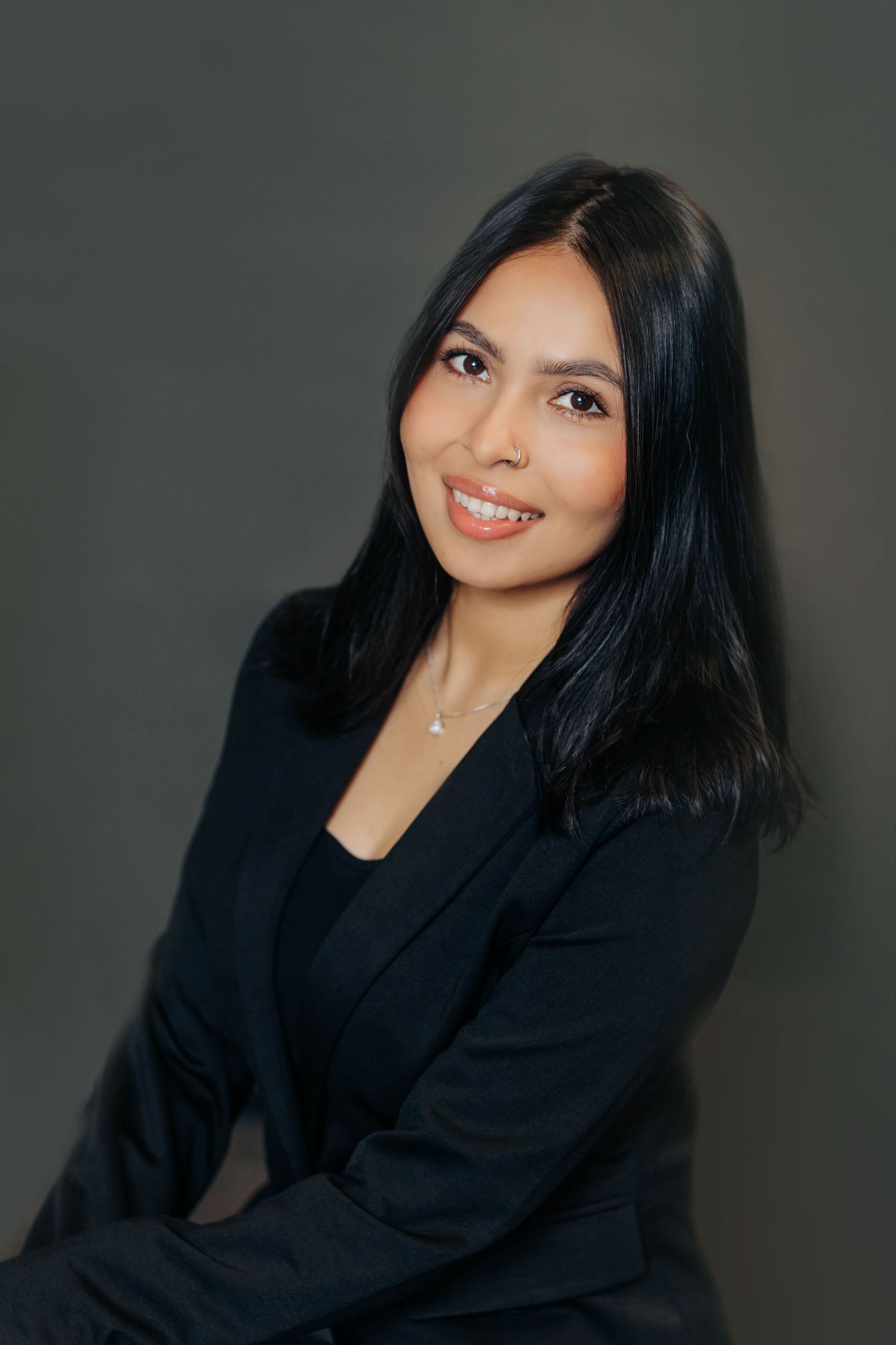 Professional headshots showing warm expressions against dark background.
