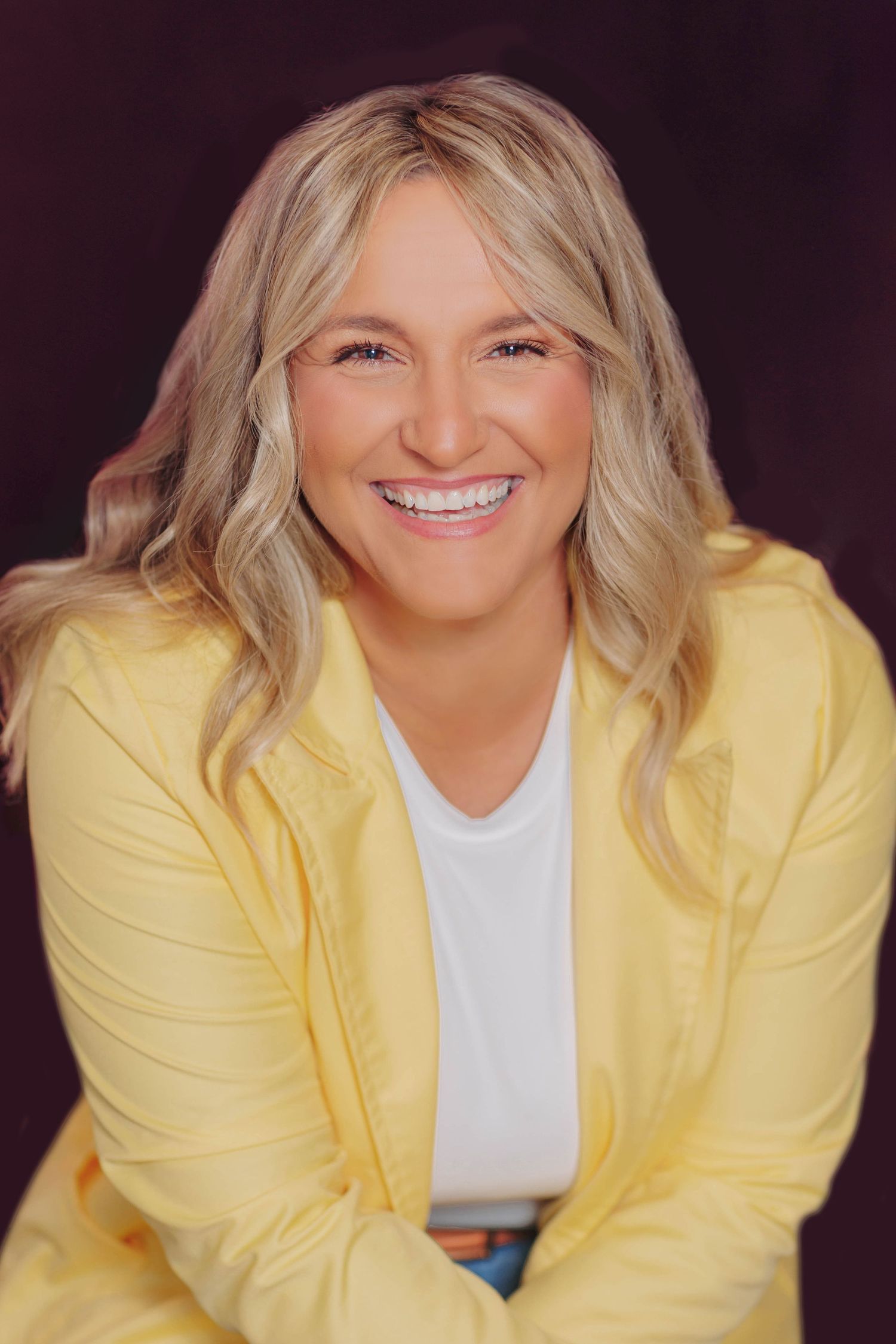 Fashion portraits showing yellow blazer styling against dark background with natural lighting.