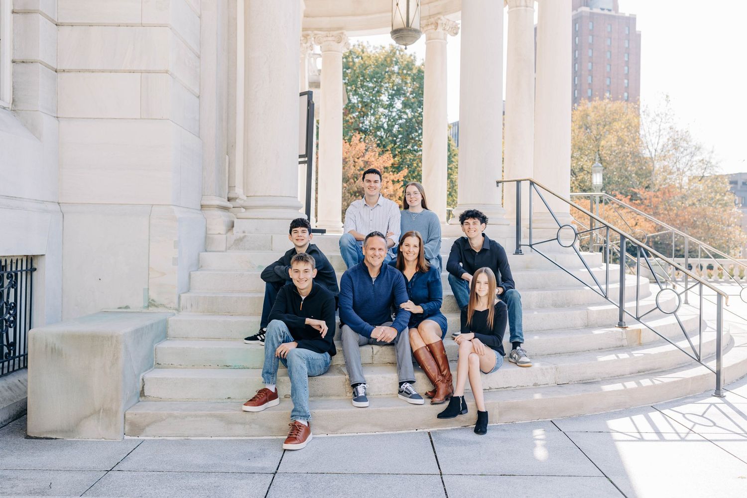 Urban family photo session on classic stone steps of historic building.