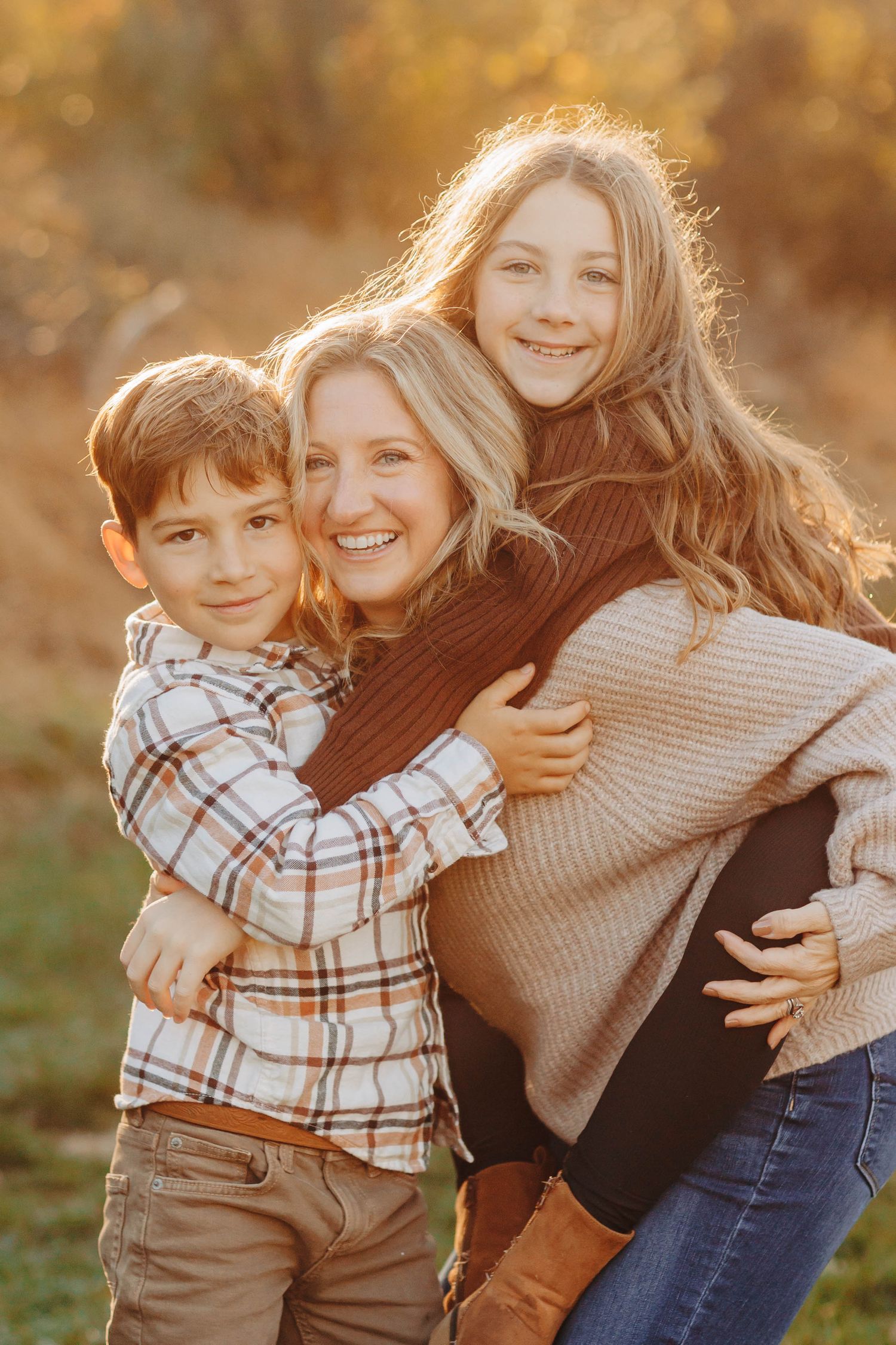 Candid outdoor family moments captured in golden sunset light.