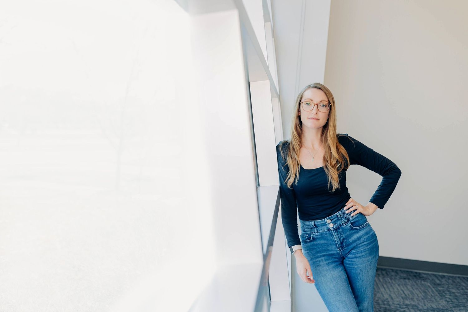 Casual lifestyle photos showing denim and navy blazer against white wall.