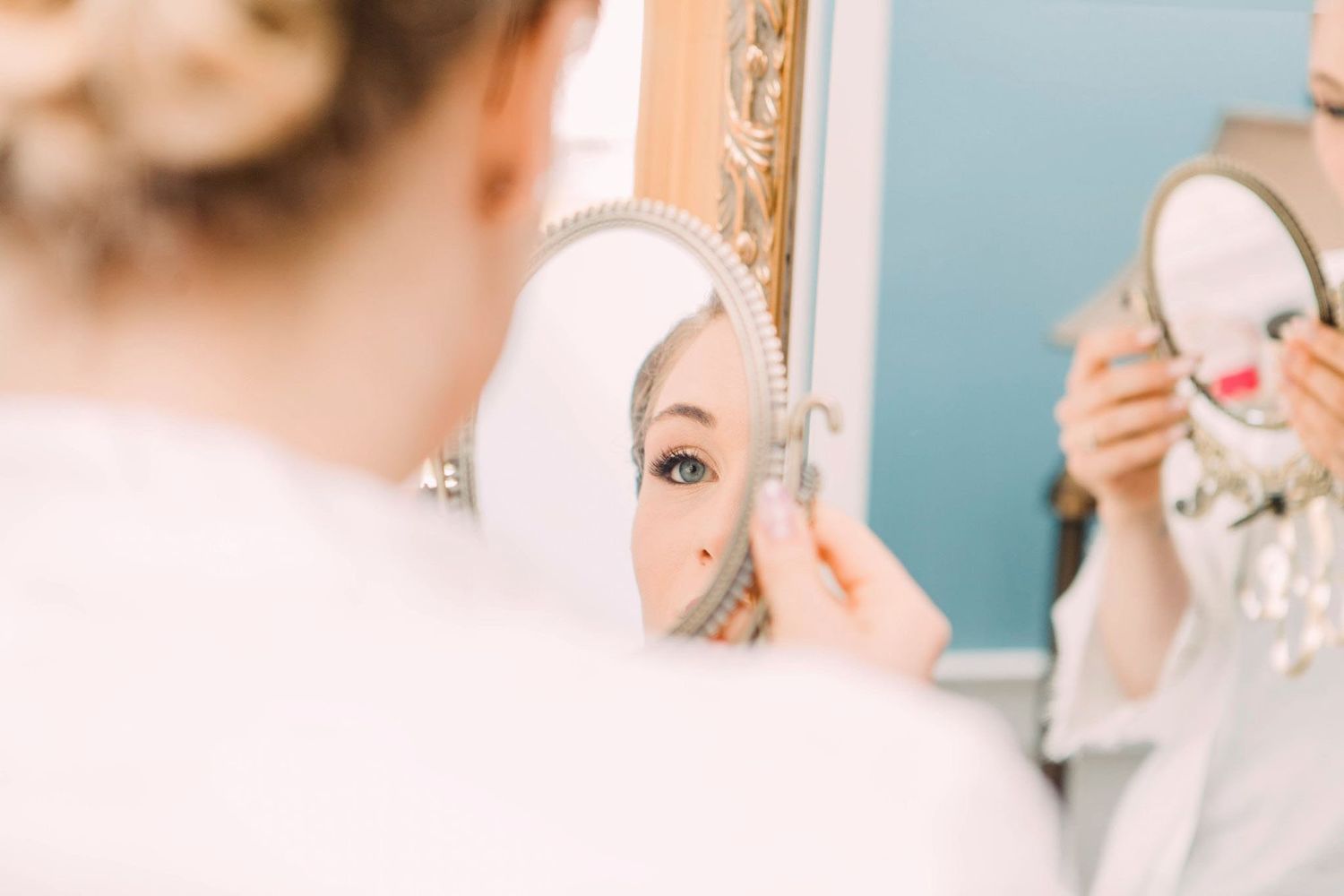Close-up beauty shot showing makeup application with cosmetic tools.