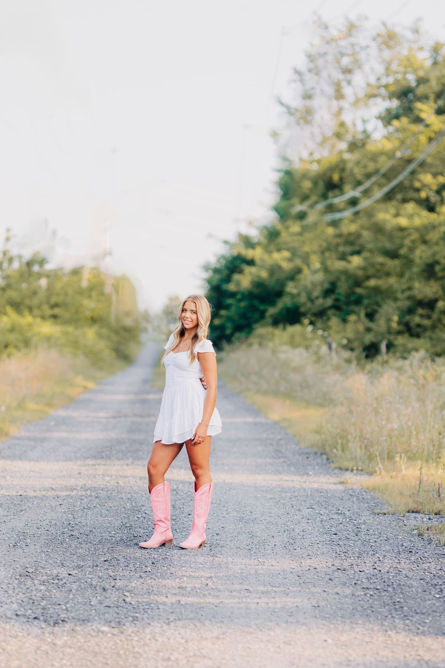 Casual portrait session on a gravel path wearing pink shoes.