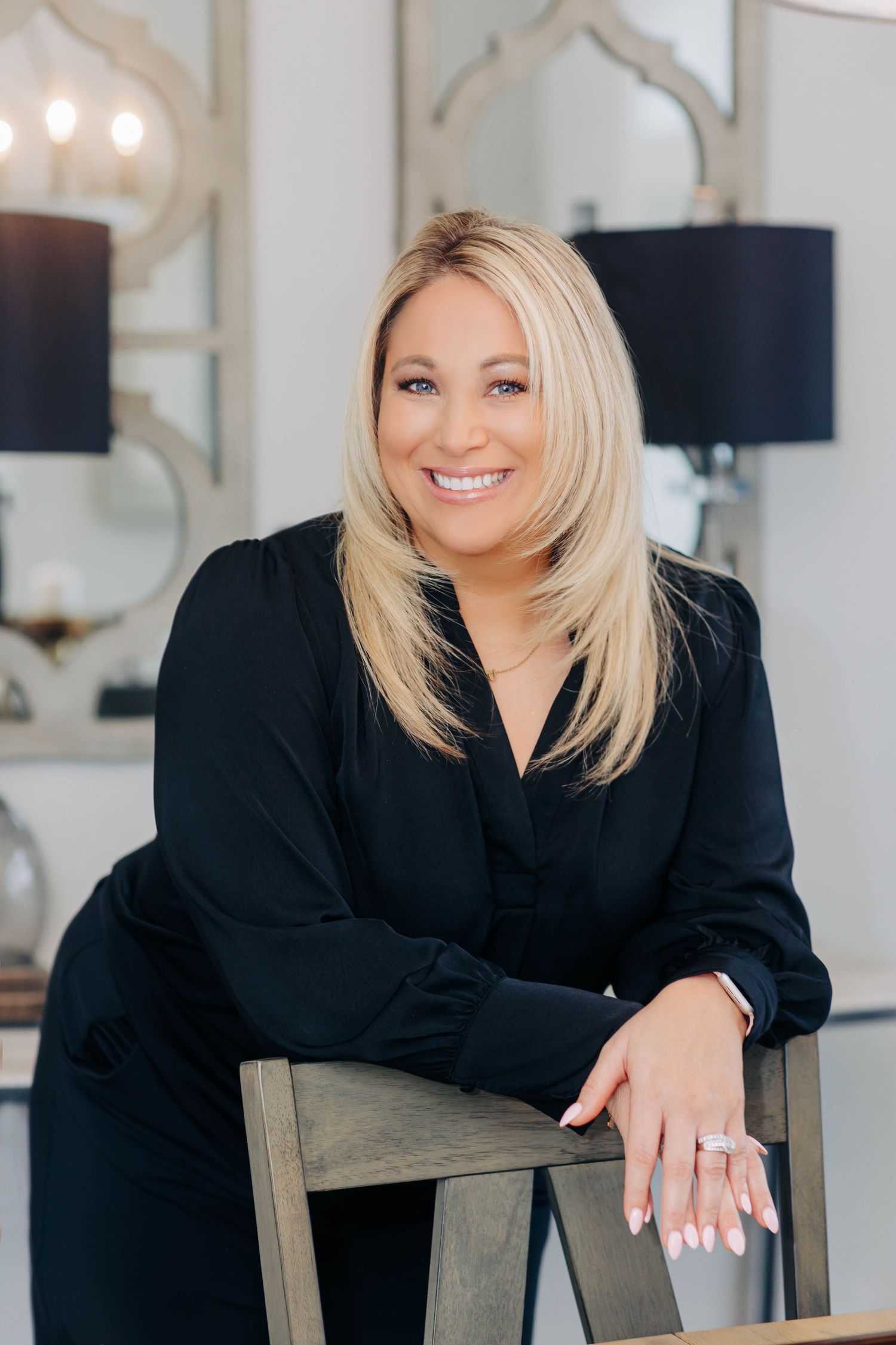 Professional headshots in black blazer against bright studio setting.