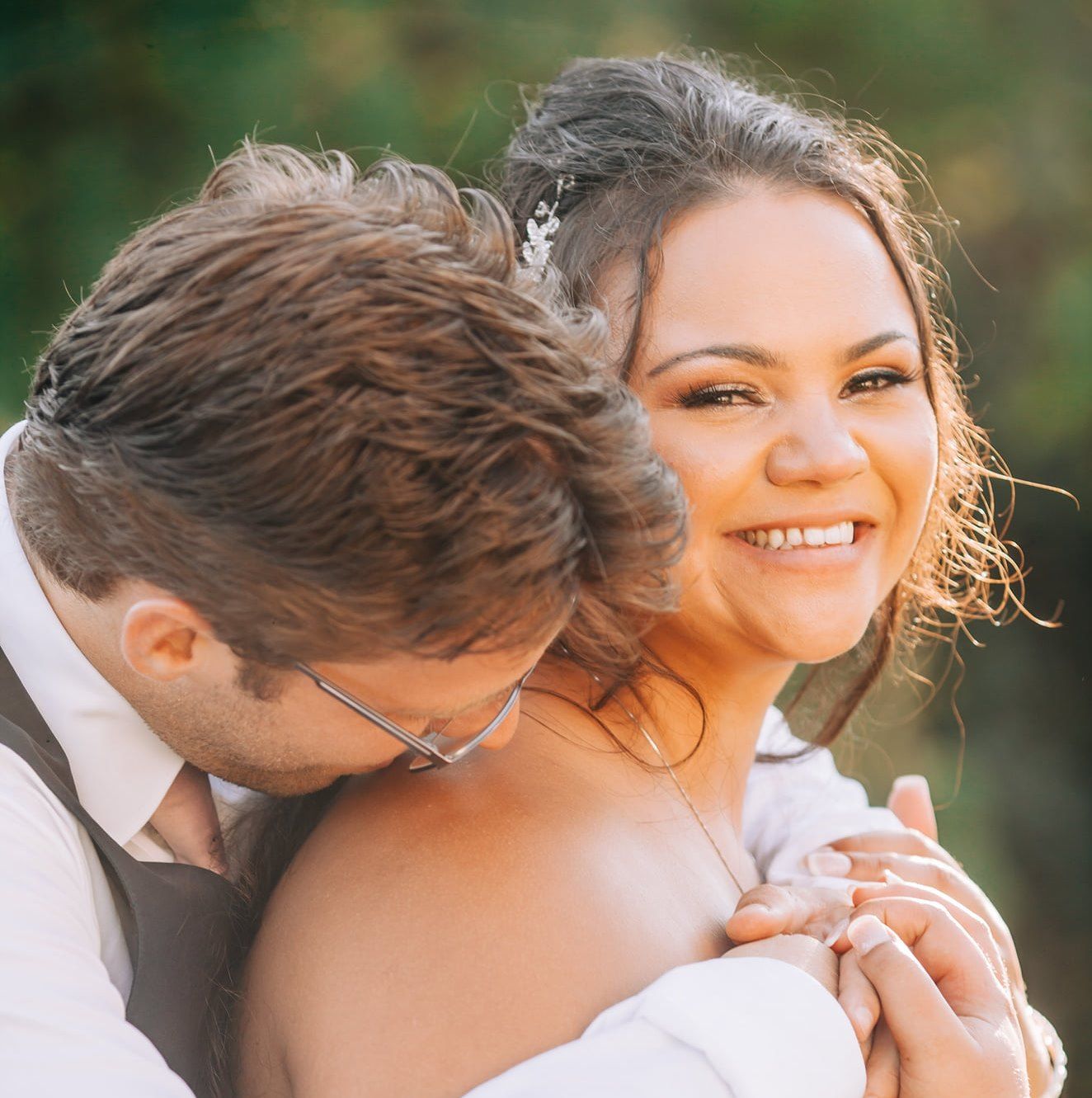 Romantic outdoor wedding portraits captured in soft natural lighting.