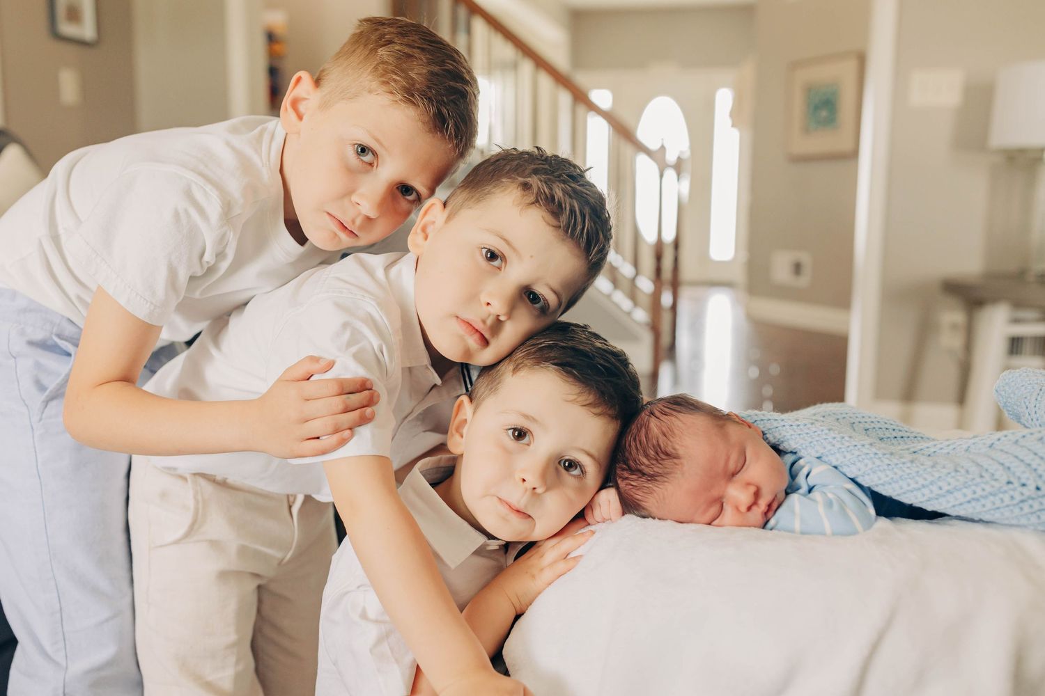 Family members cuddling together on bed showing tender affection and love.