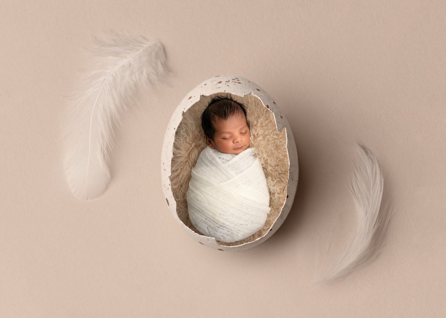 A series of artistic photos showing a sleeping baby wrapped in white fabric in different positions on a beige background.