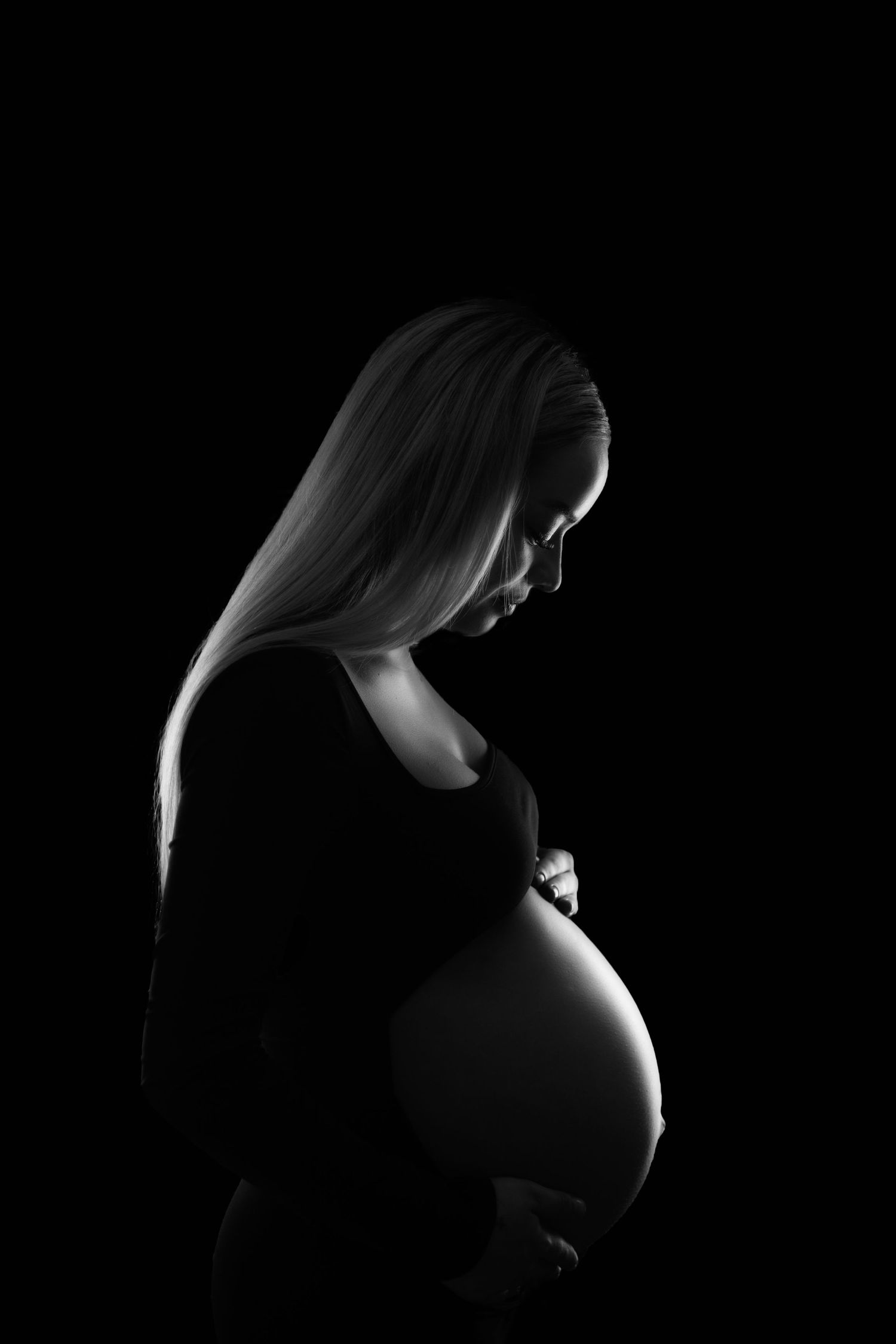 A dramatic black and white silhouette profile series showing a woman's head in progressive angles against a dark background.