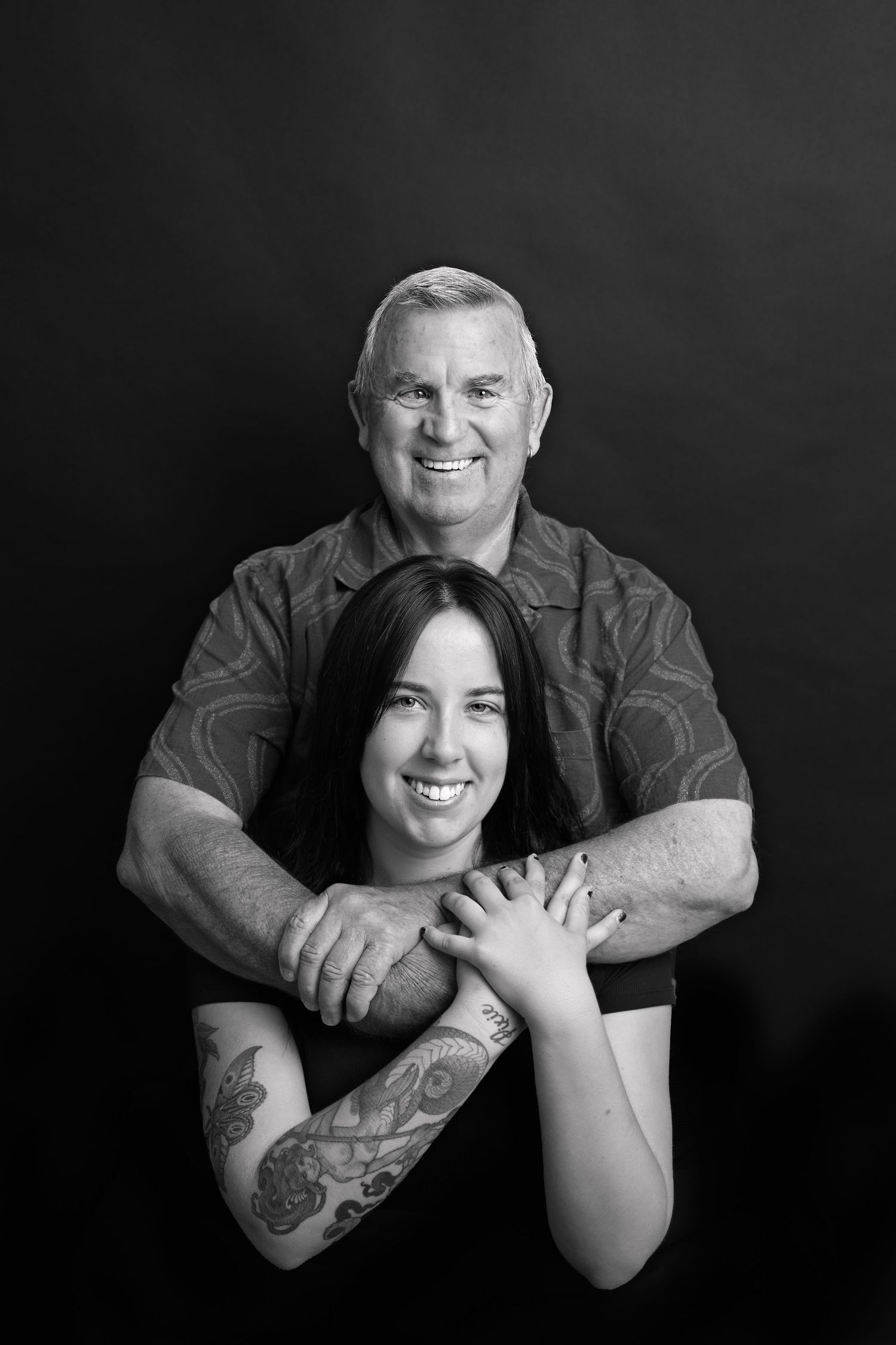 Black and white portrait series showing close emotional connection between two people in dramatic lighting.