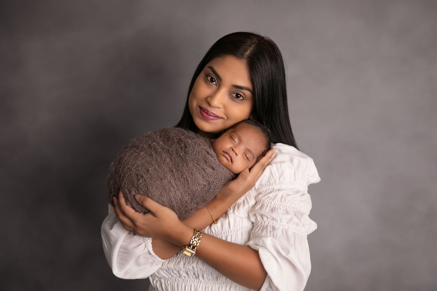A series of intimate portrait photographs showing tender embraces between parent and child in soft lighting.