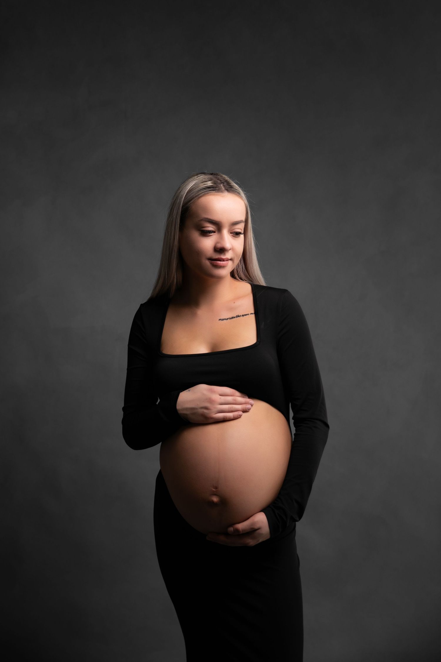 A maternity photo series shows a woman in black against a dark background cradling her pregnant belly.