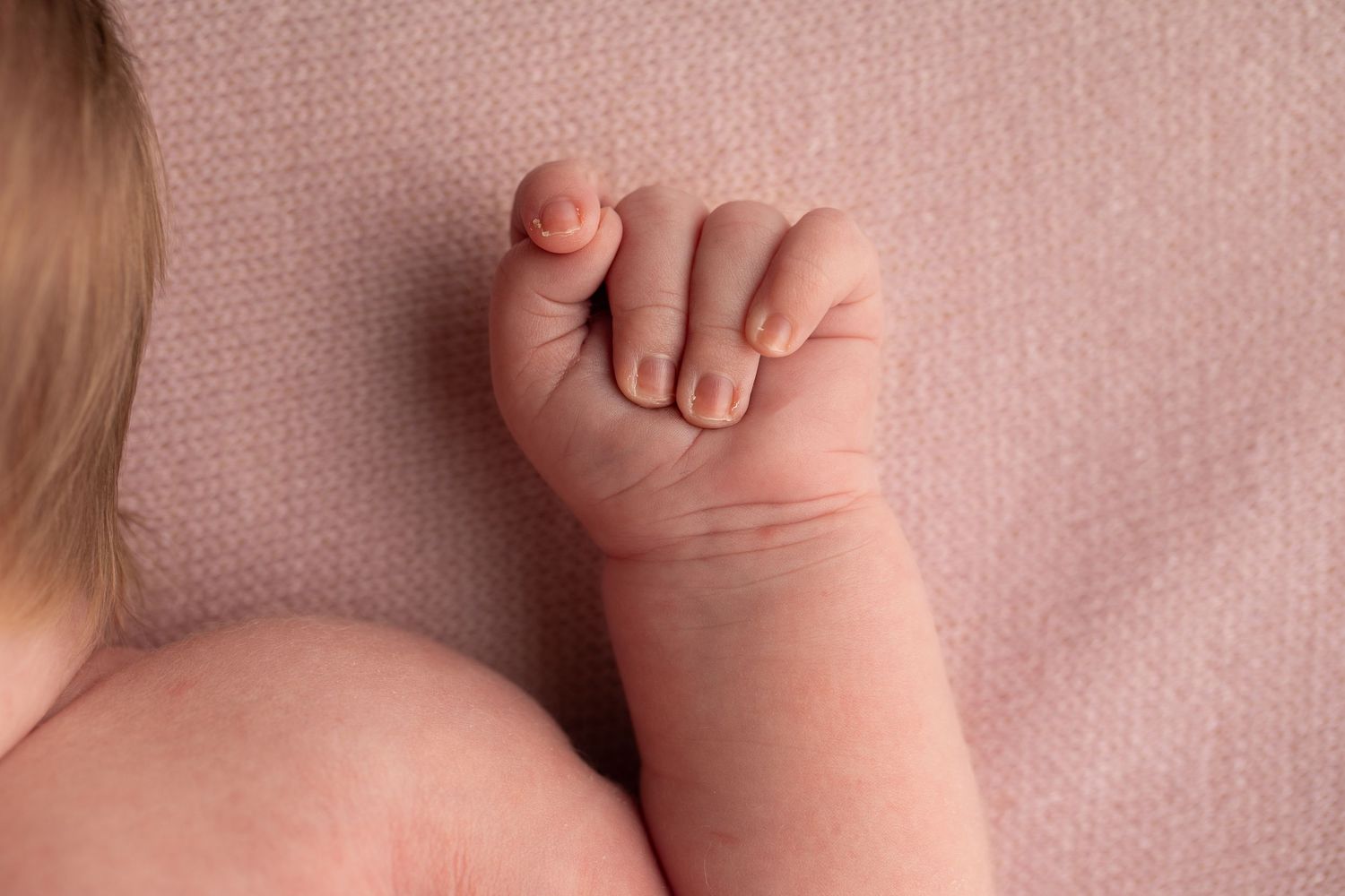 A series of close-up photos showing tiny baby feet and toes against a soft pink background.