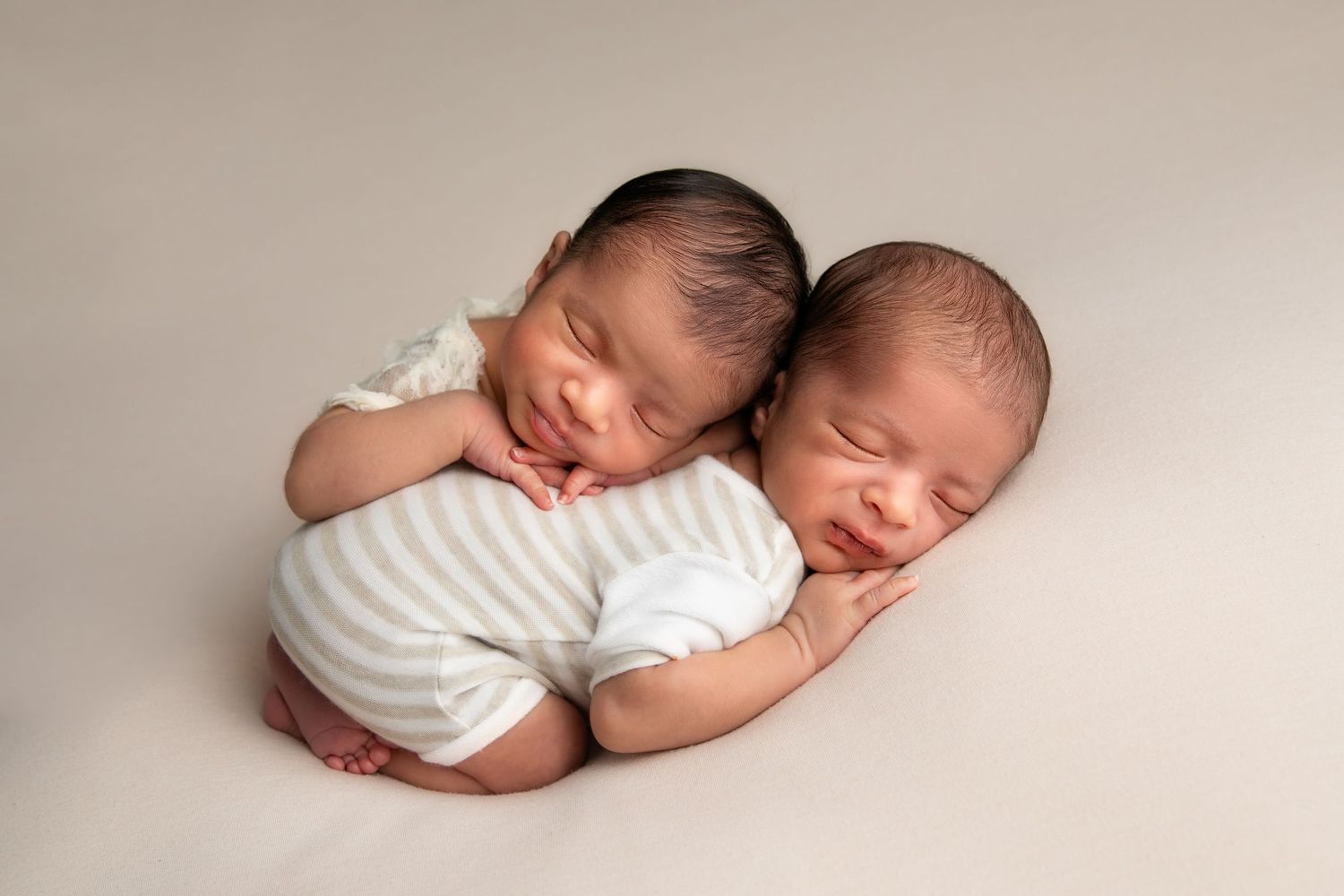 A series of peaceful newborn baby photos showing sleeping infants in soft white wraps against neutral backgrounds.
