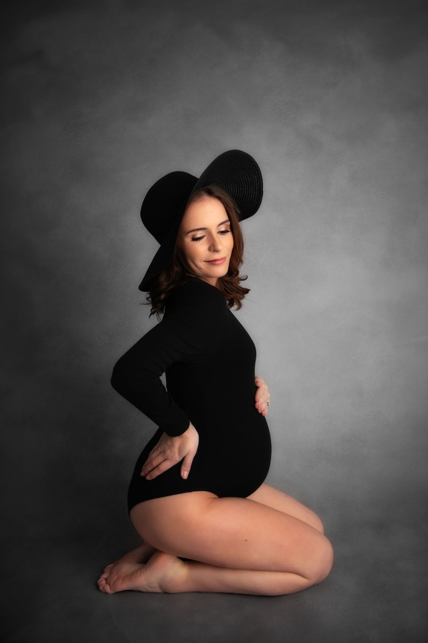 Artistic boudoir photo series showing silhouette poses against dark background in black dress and hat.