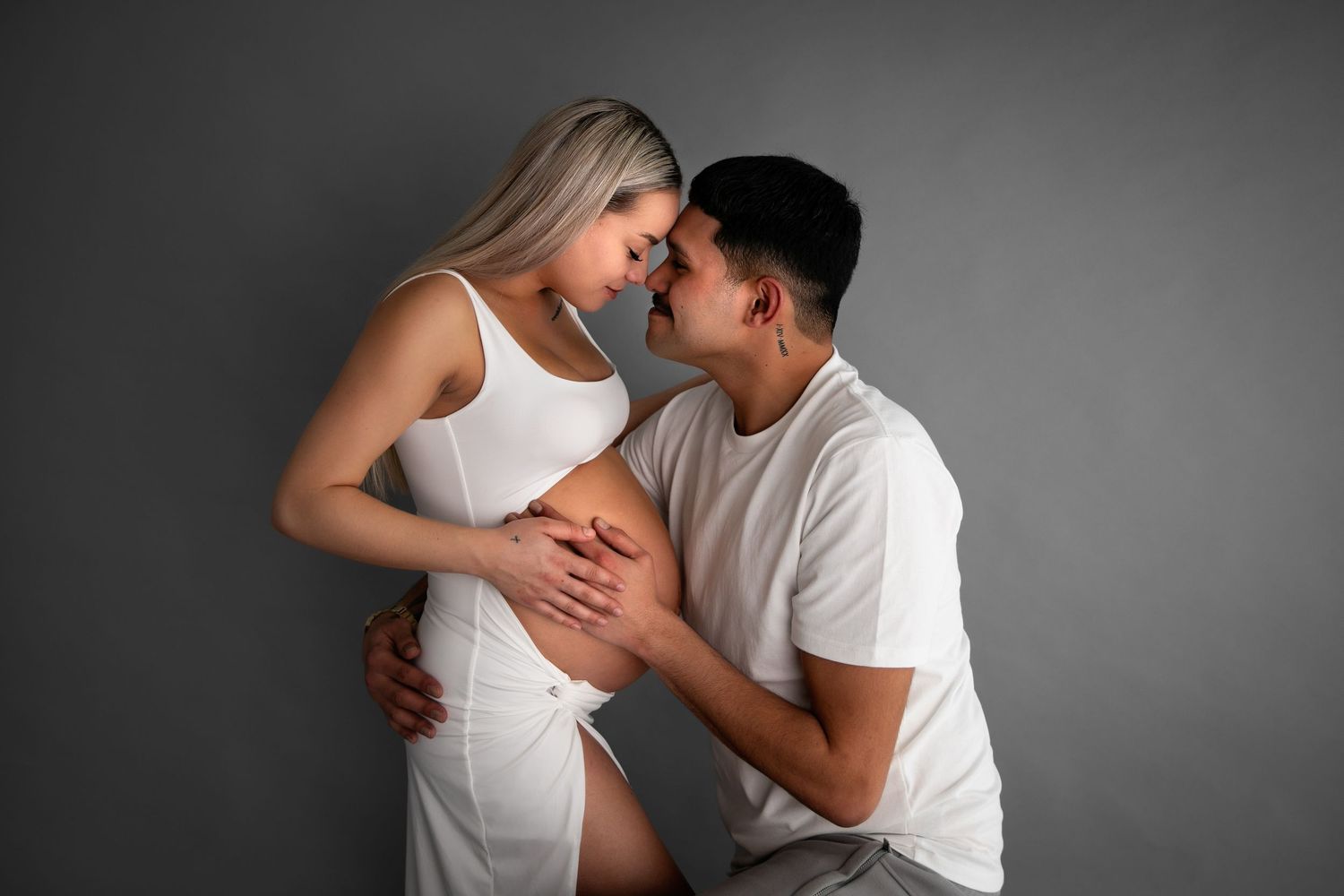Romantic black and white photo series showing tender moments between a couple wearing white clothing.